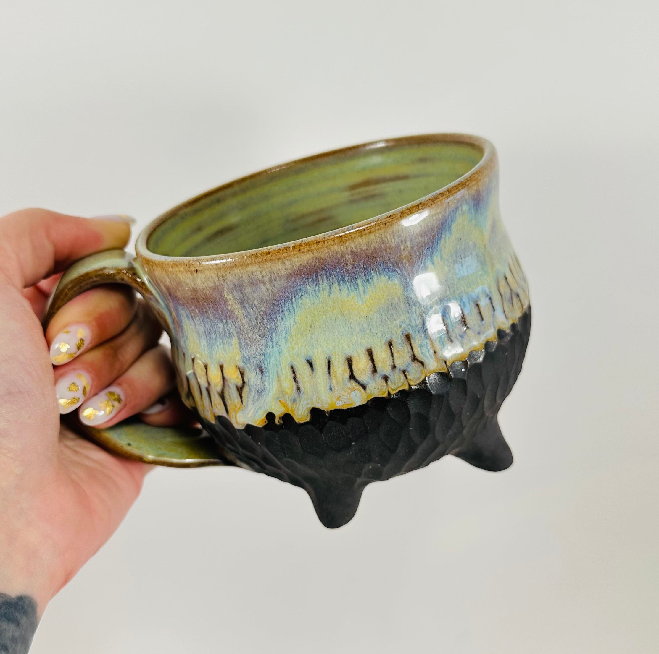 Handmade cauldron mug in a beautiful green, blue and black glaze