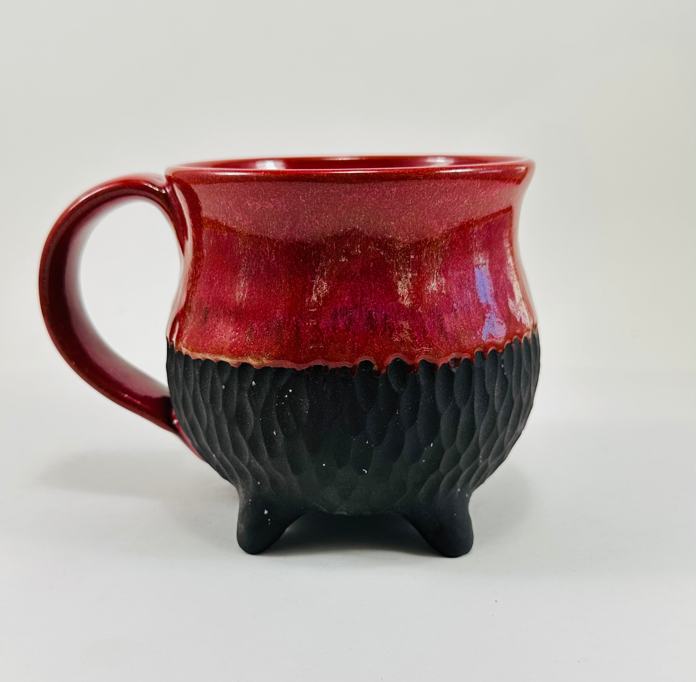 Handmade cauldron mug in a beautiful red and black glaze