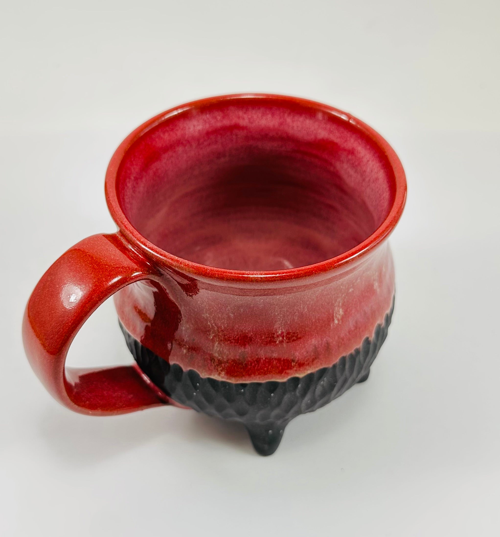 Handmade cauldron mug in a beautiful red and black glaze