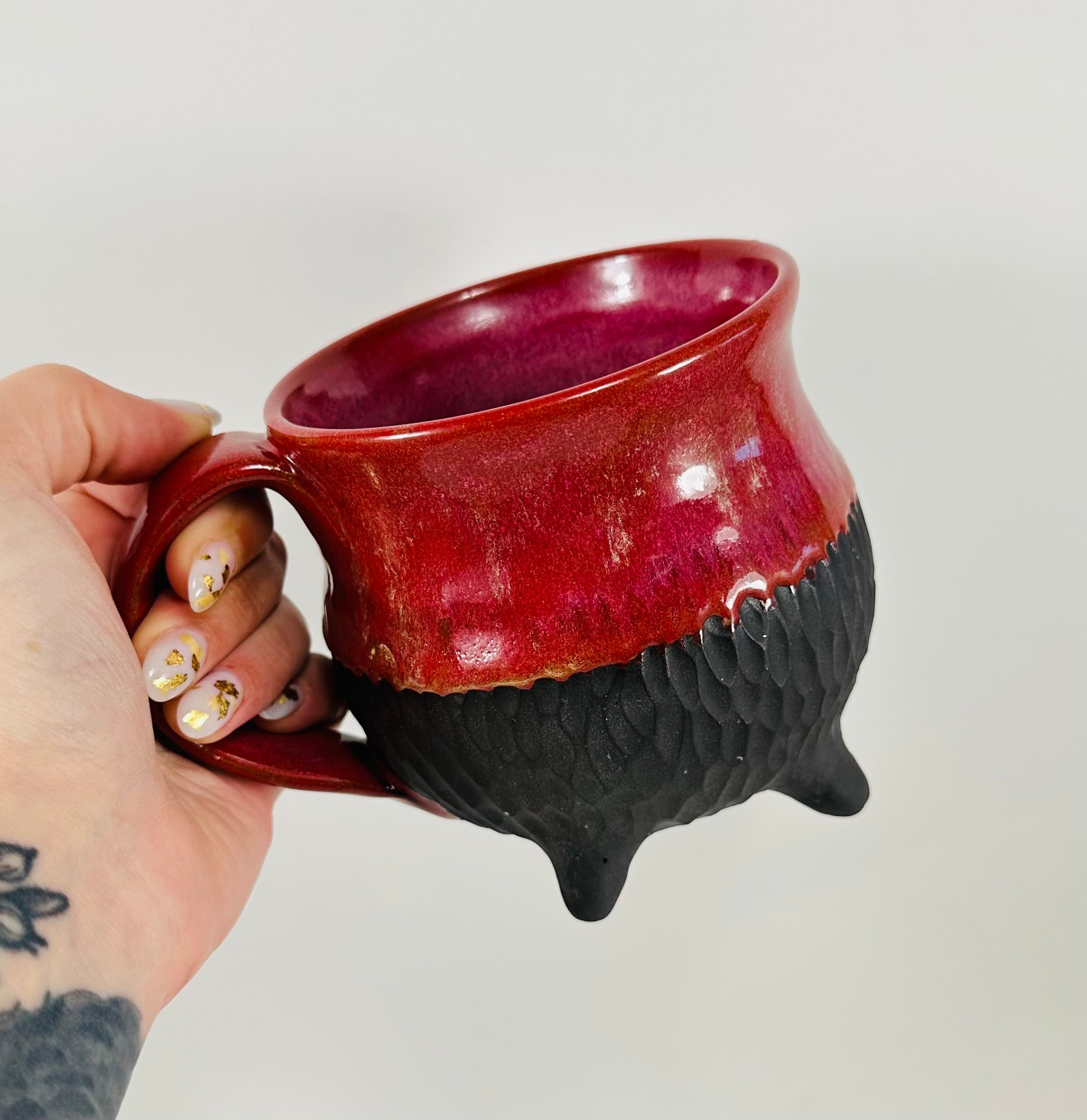 Handmade cauldron mug in a beautiful red and black glaze