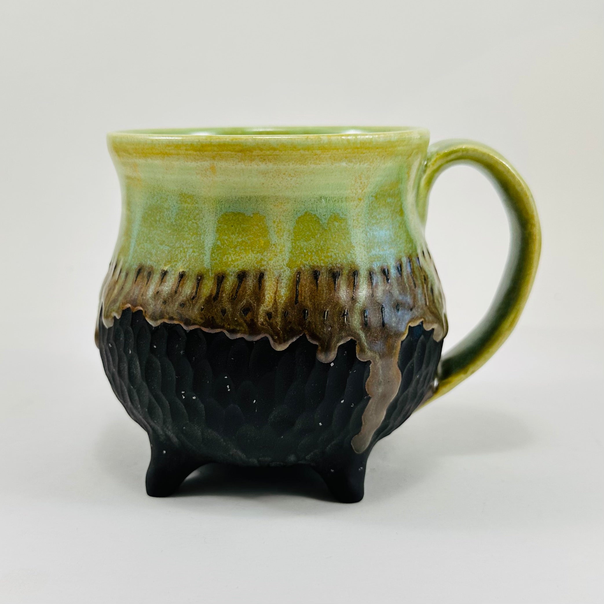 Handmade cauldron mug in a beautiful green and black glaze