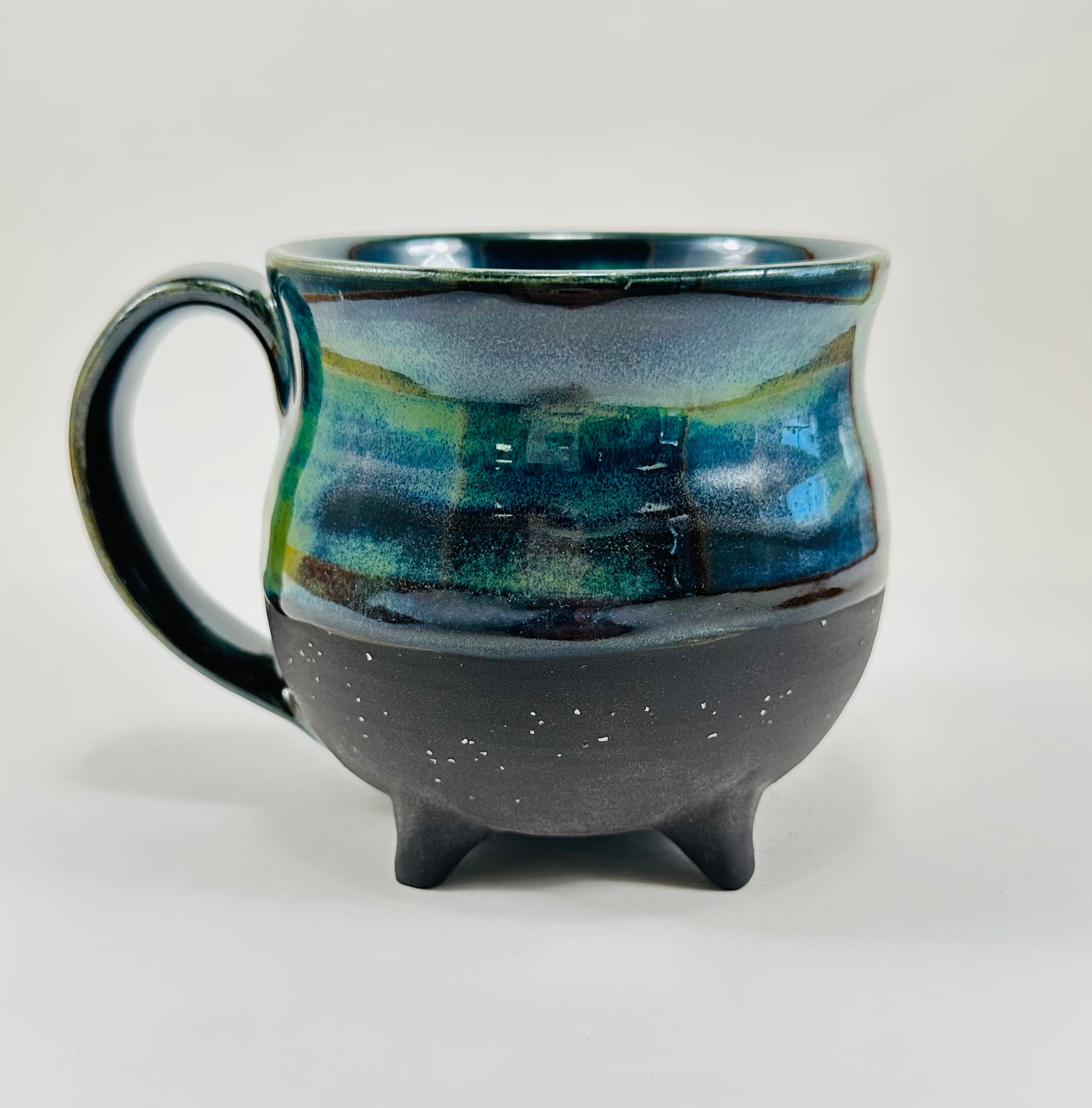 Handmade cauldron mug in a beautiful blue, green and black glaze