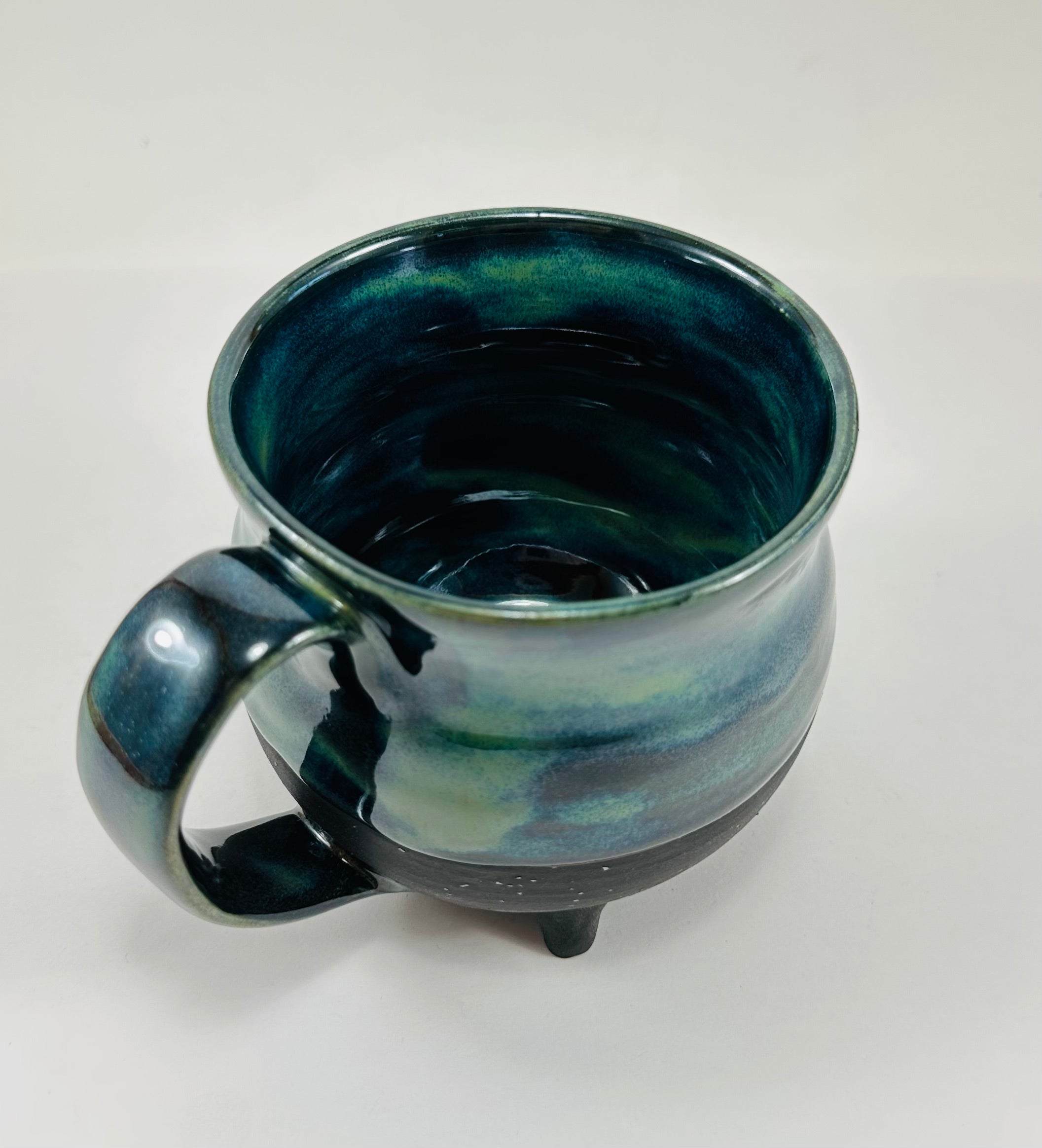 Handmade cauldron mug in a beautiful blue, green and black glaze