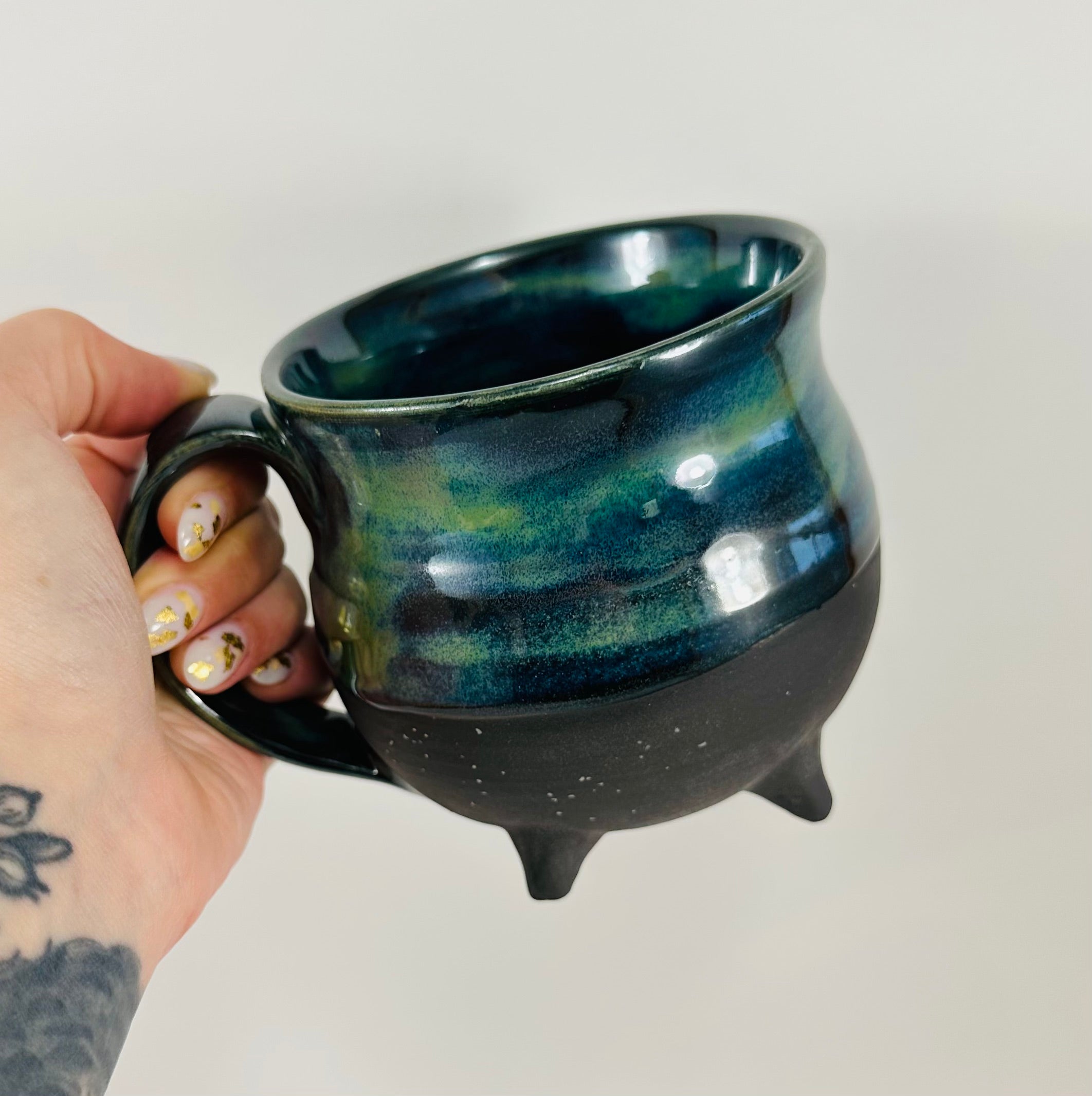Handmade cauldron mug in a beautiful blue, green and black glaze