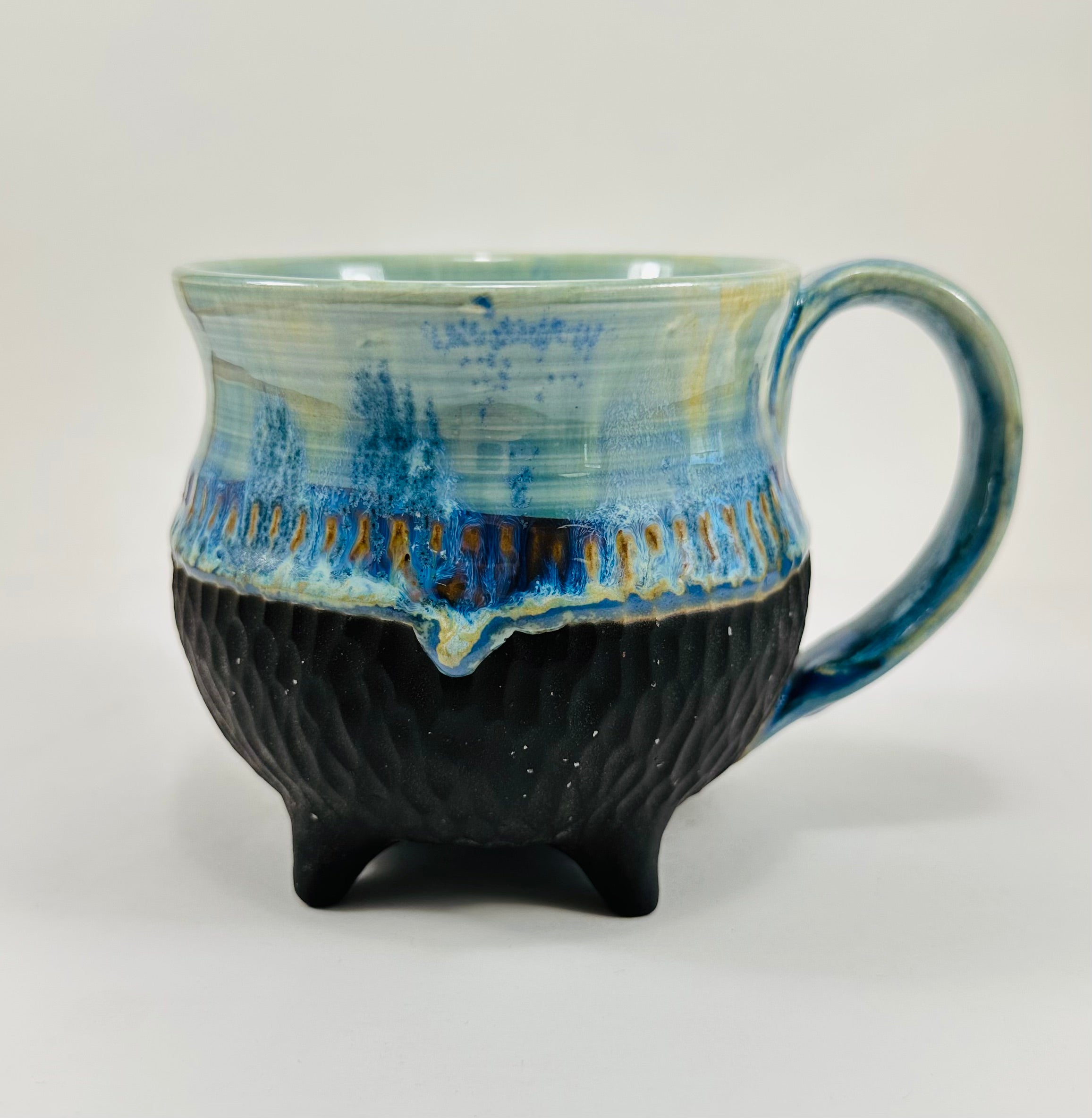 Handmade cauldron mug in a beautiful blue and black glaze