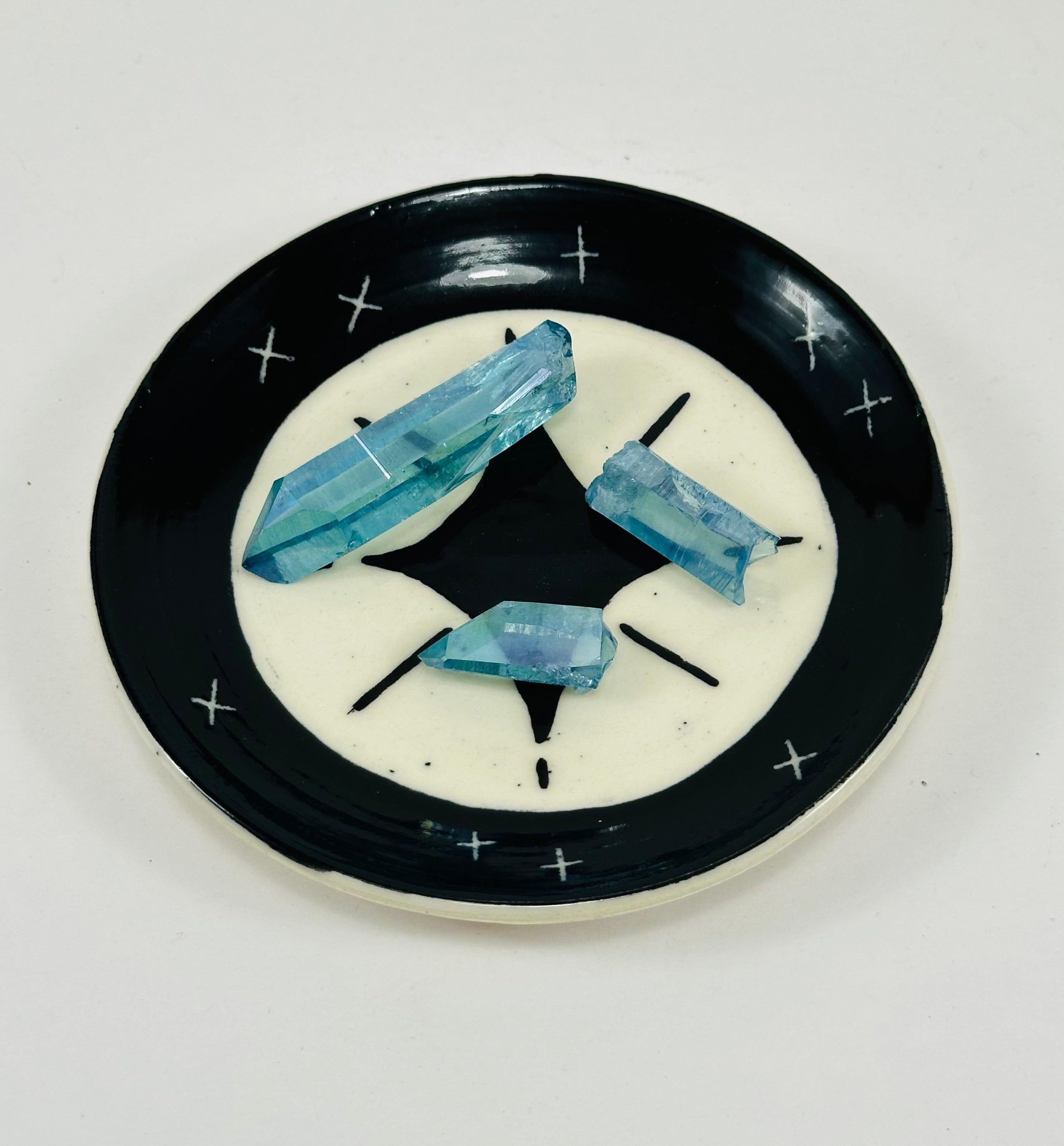 Handmade trinket dish in black and white glaze with stars.