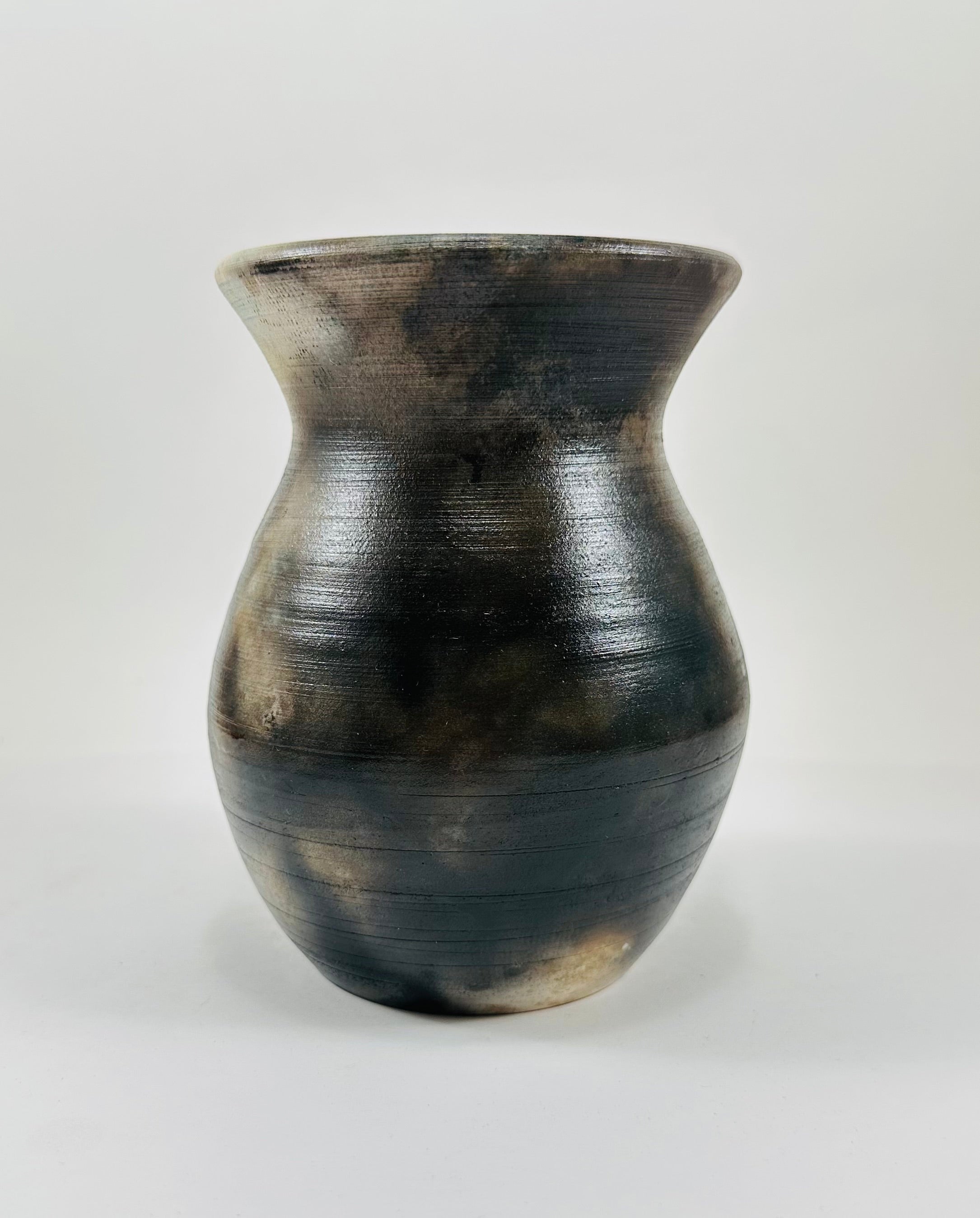 Handmade vase with a brown, white, black and yellow smokey finish.