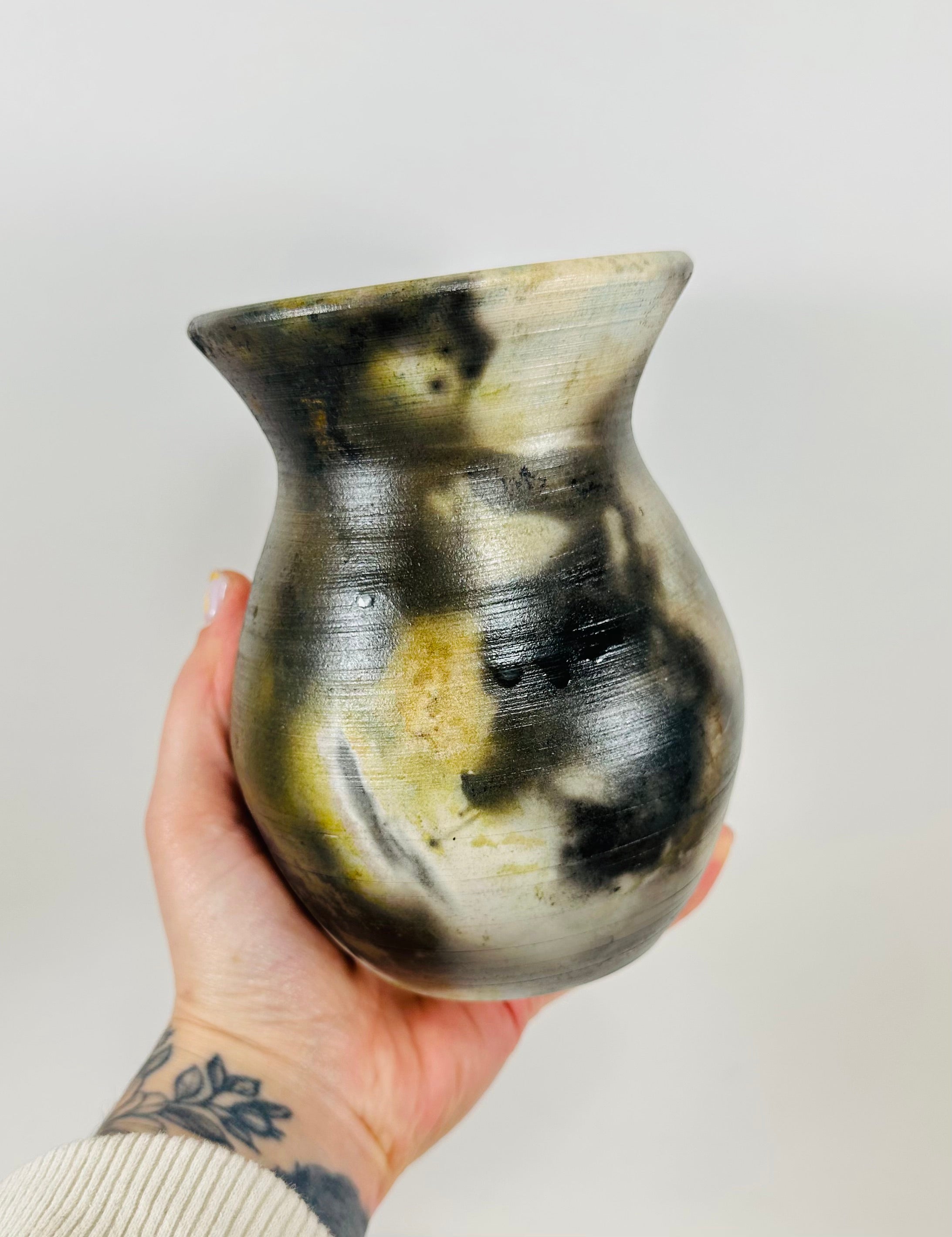 Handmade vase with a brown, white, black and yellow smokey finish.