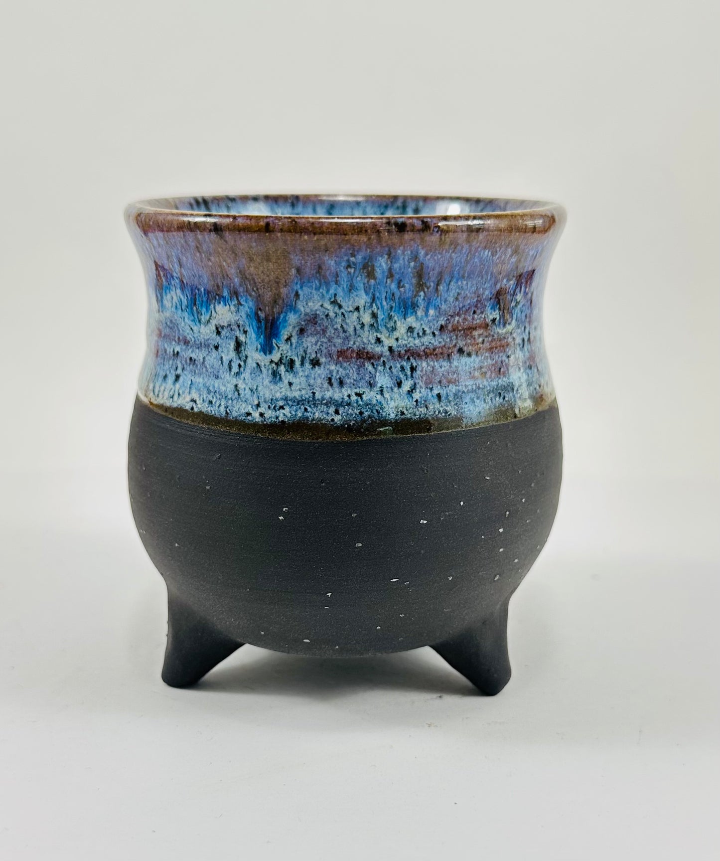 A handmade ceramic cauldron in a beautiful blue and black glaze.