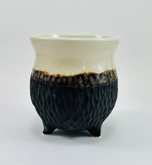 A handmade ceramic cauldron in a beautiful white and brown glaze.