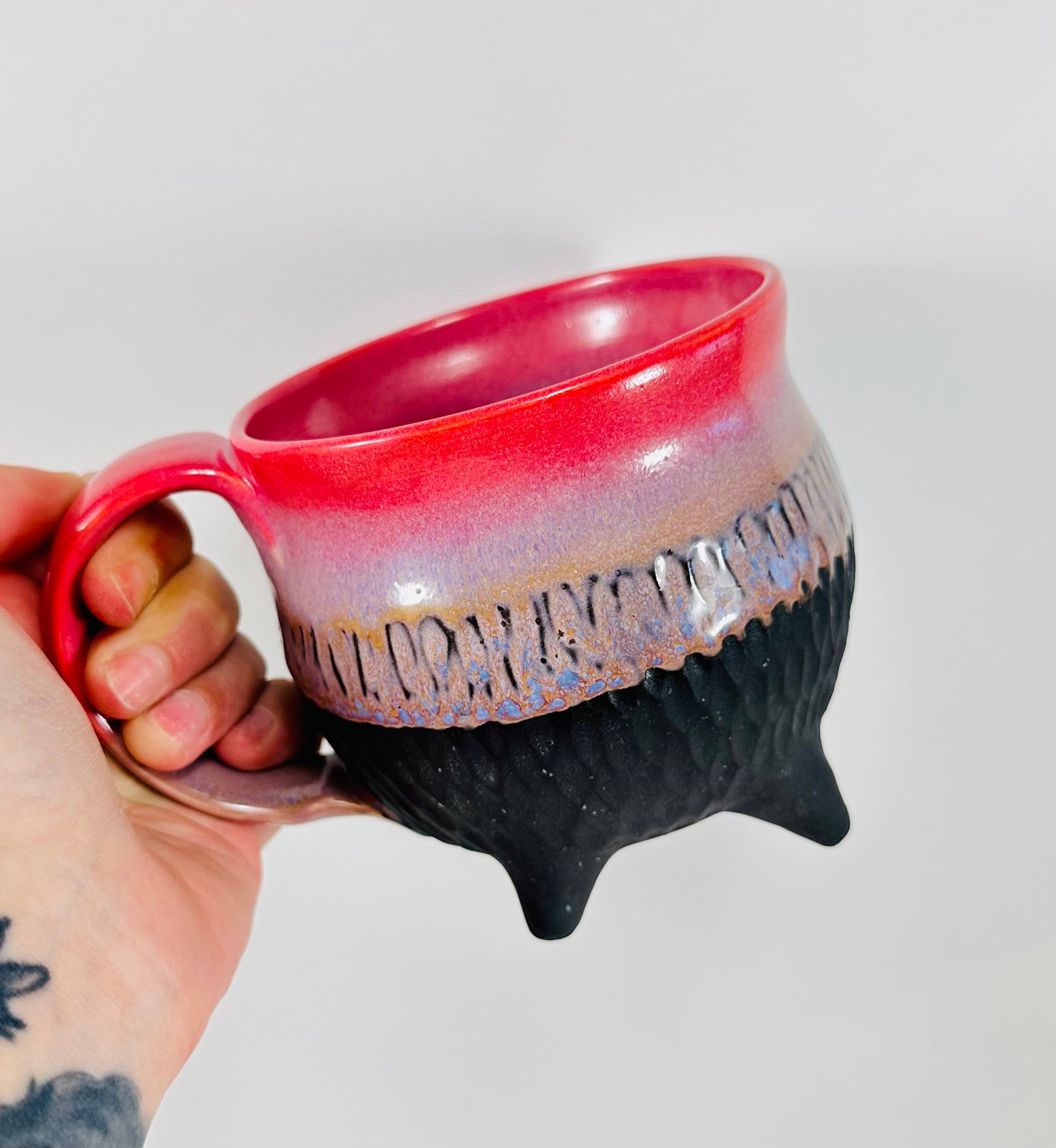 Handmade ceramic cauldron mug in a beautiful pink, purple and black glaze.