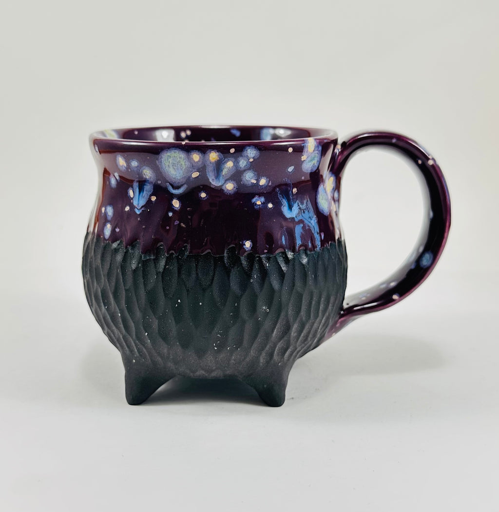 Handmade ceramic cauldron mug in a beautiful purple and black glaze.