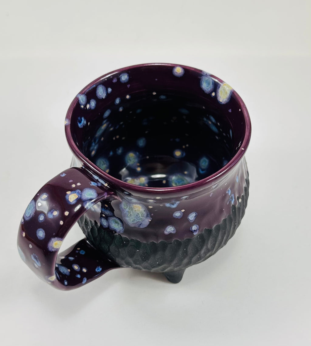 Handmade ceramic cauldron mug in a beautiful purple and black glaze.