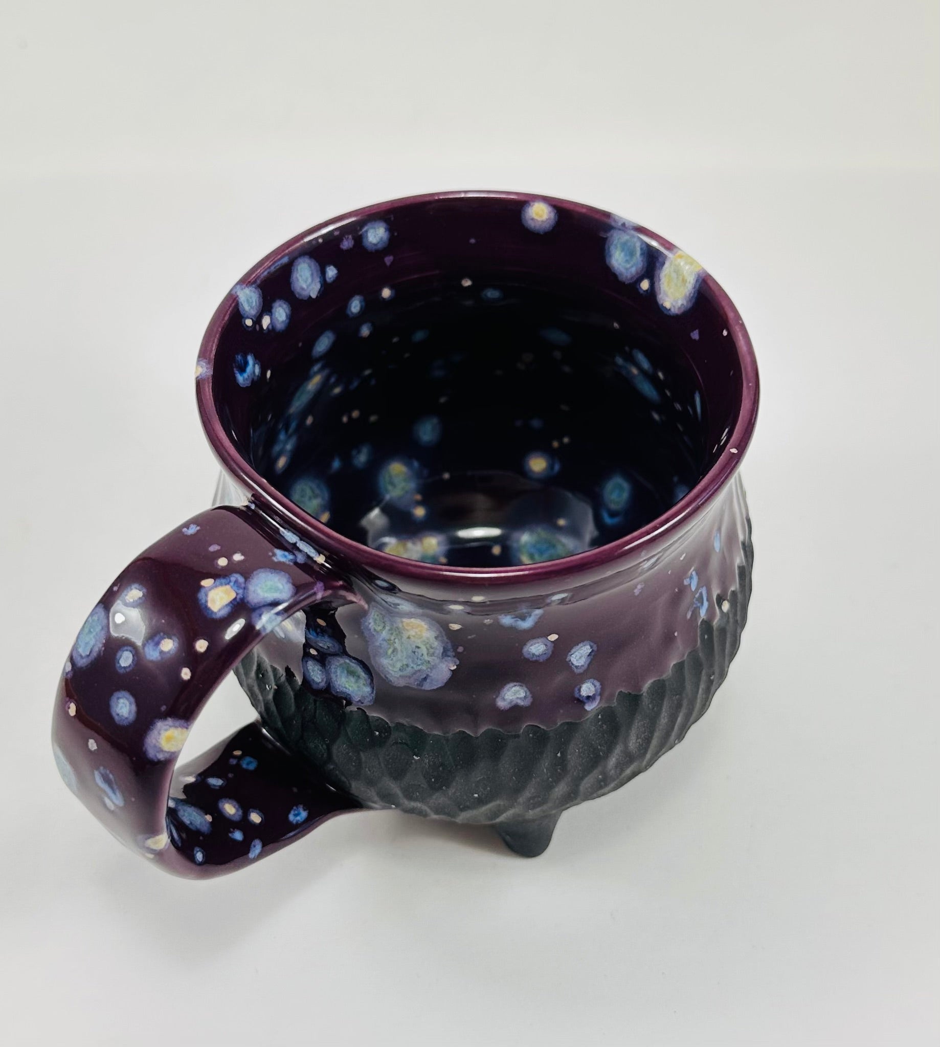 Handmade ceramic cauldron mug in a beautiful purple and black glaze.