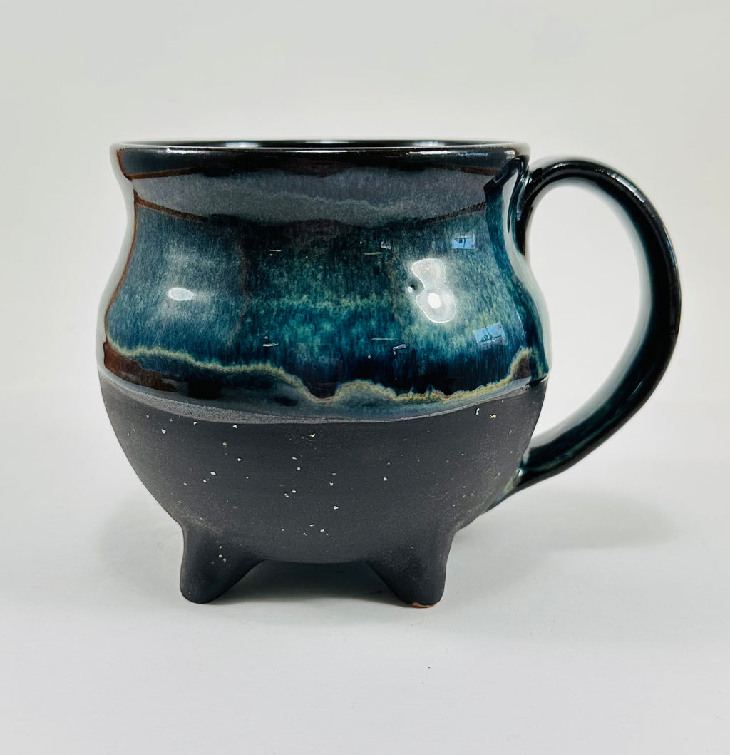 Handmade cauldron mug in a beautiful blue and black glaze.