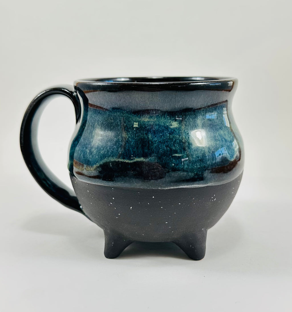 Handmade cauldron mug in a beautiful blue and black glaze.