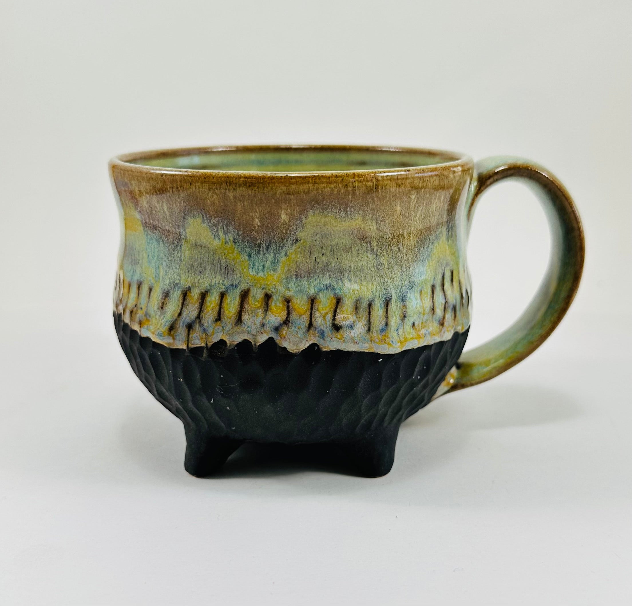 Handmade cauldron mug in a beautiful green, blue and black glaze