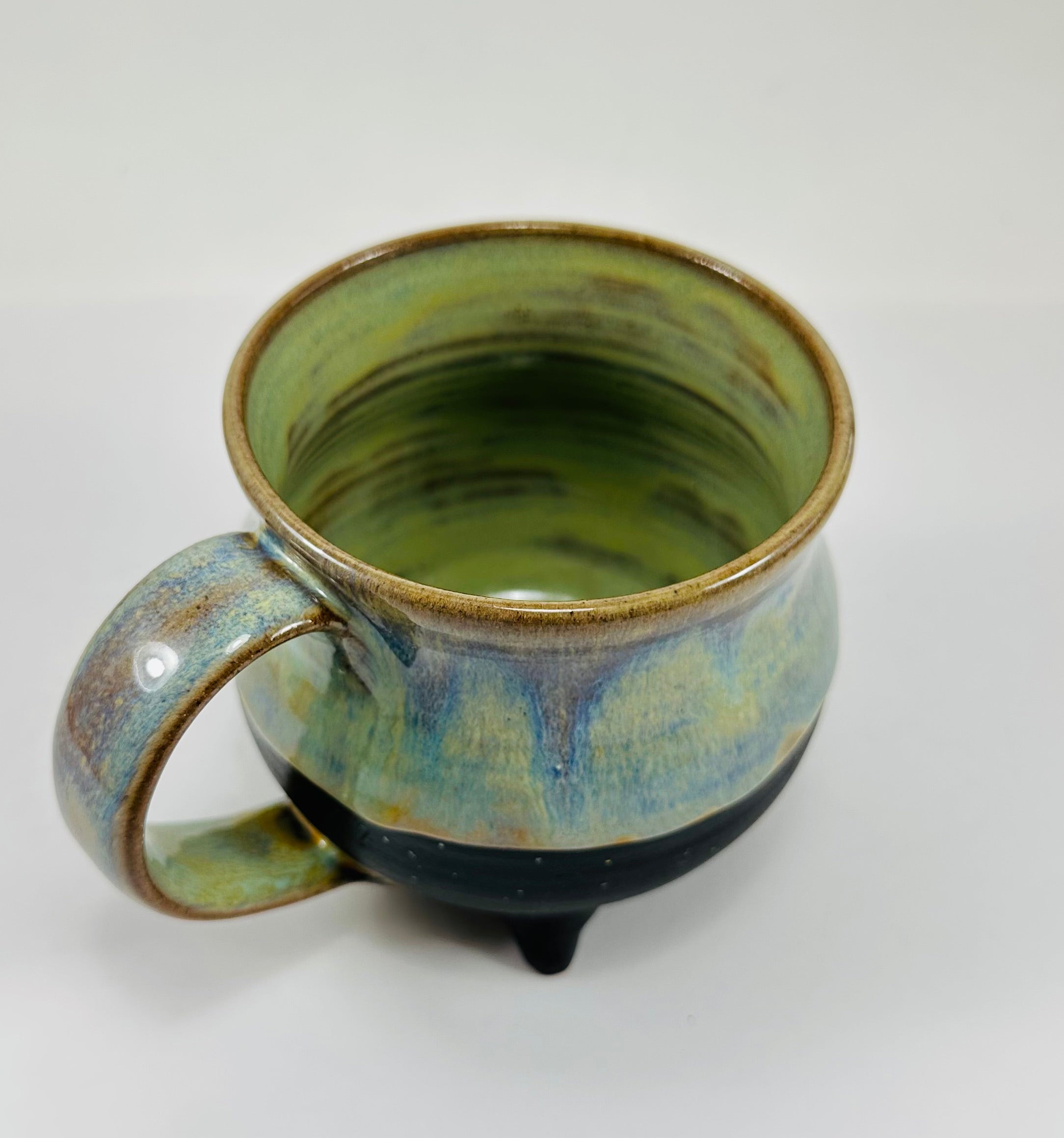 Handmade cauldron mug in a beautiful green, blue and black glaze
