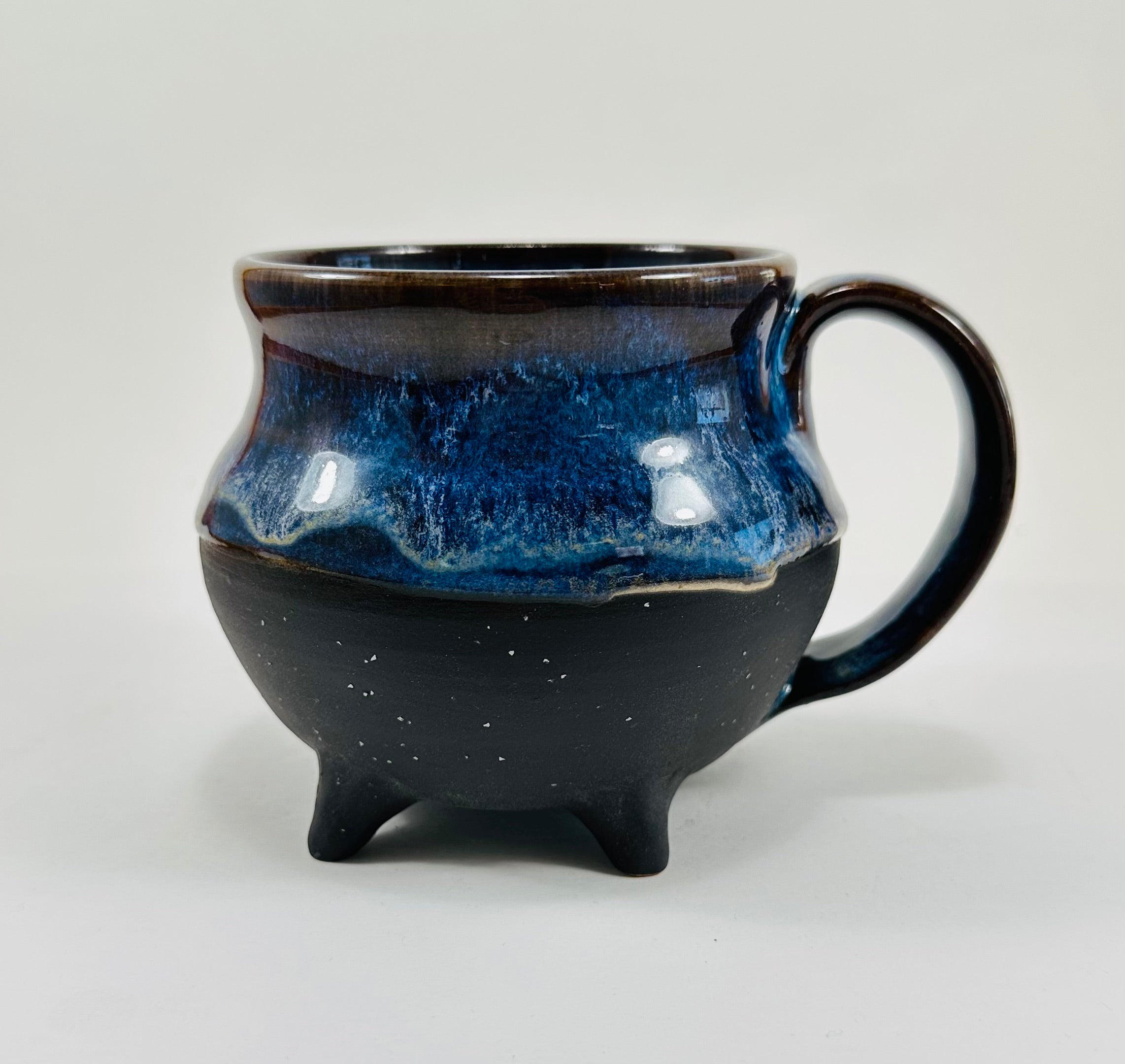 Handmade cauldron mug in a beautiful blue and black glaze