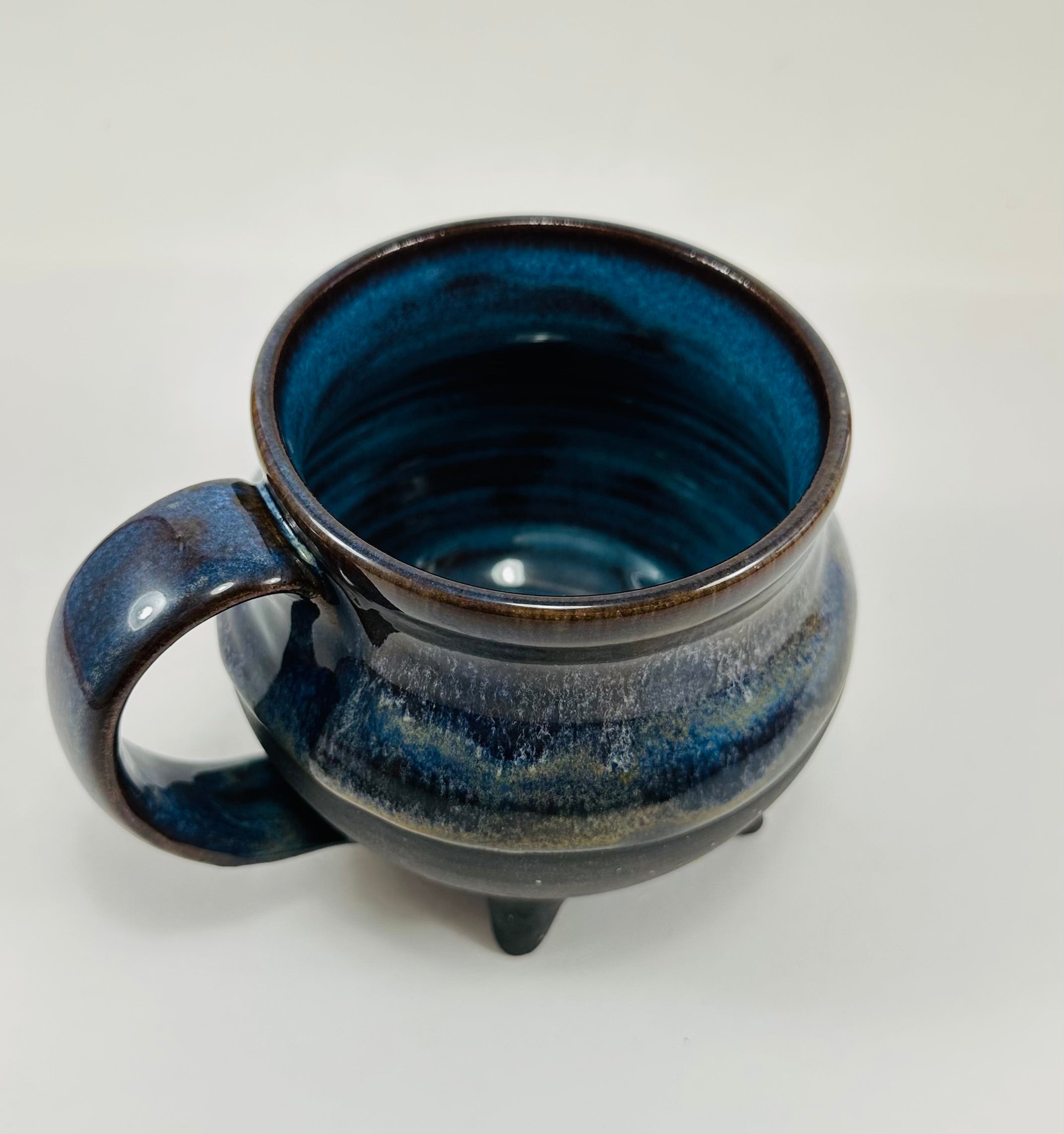 Handmade cauldron mug in a beautiful blue and black glaze