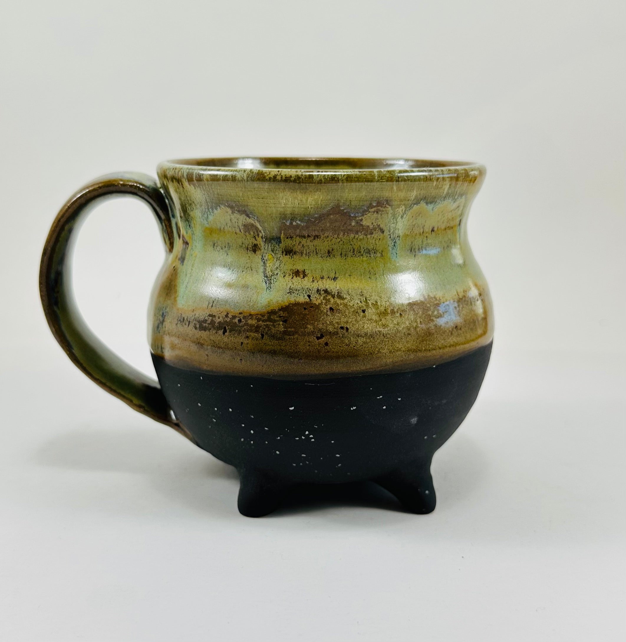 Handmade cauldron mug in a beautiful green and black glaze