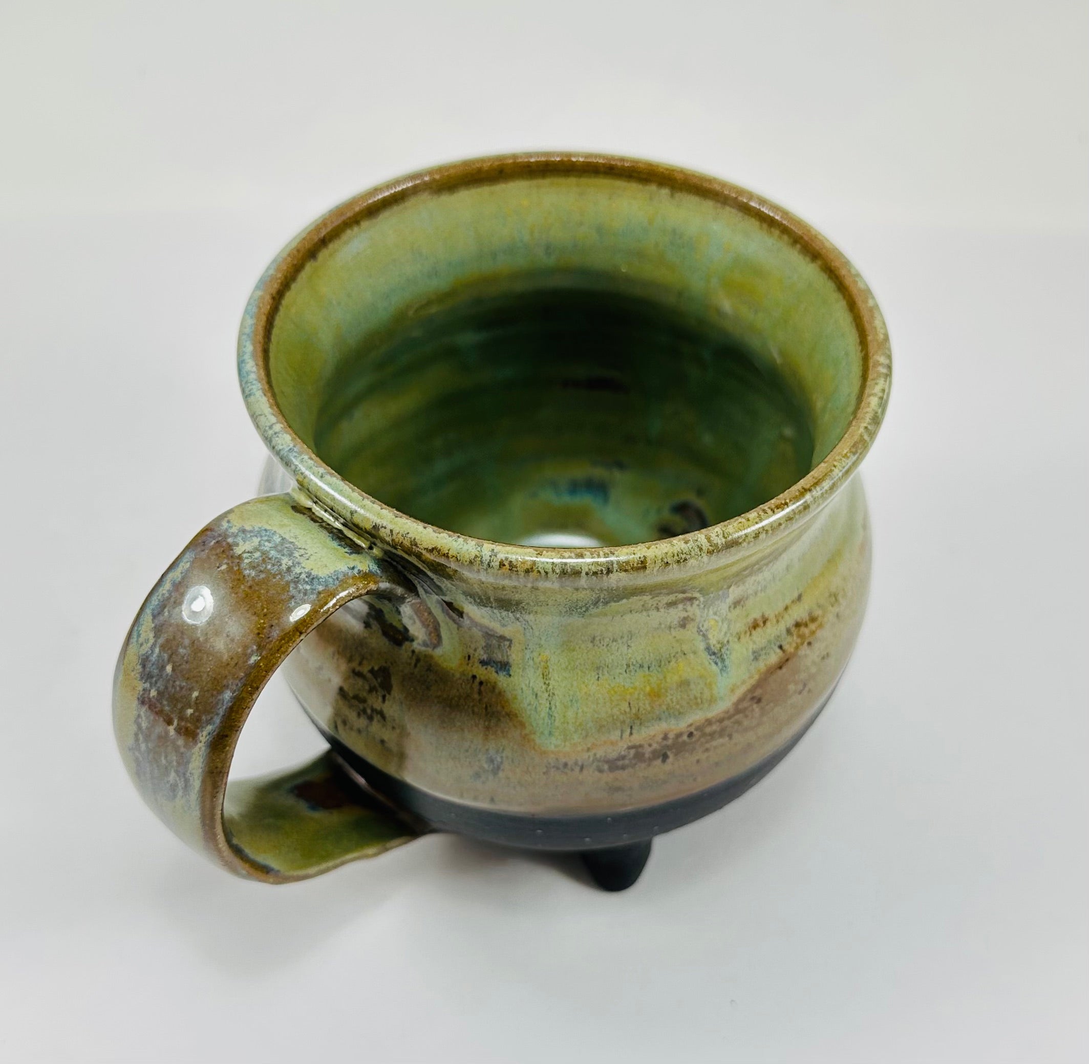 Handmade cauldron mug in a beautiful green and black glaze