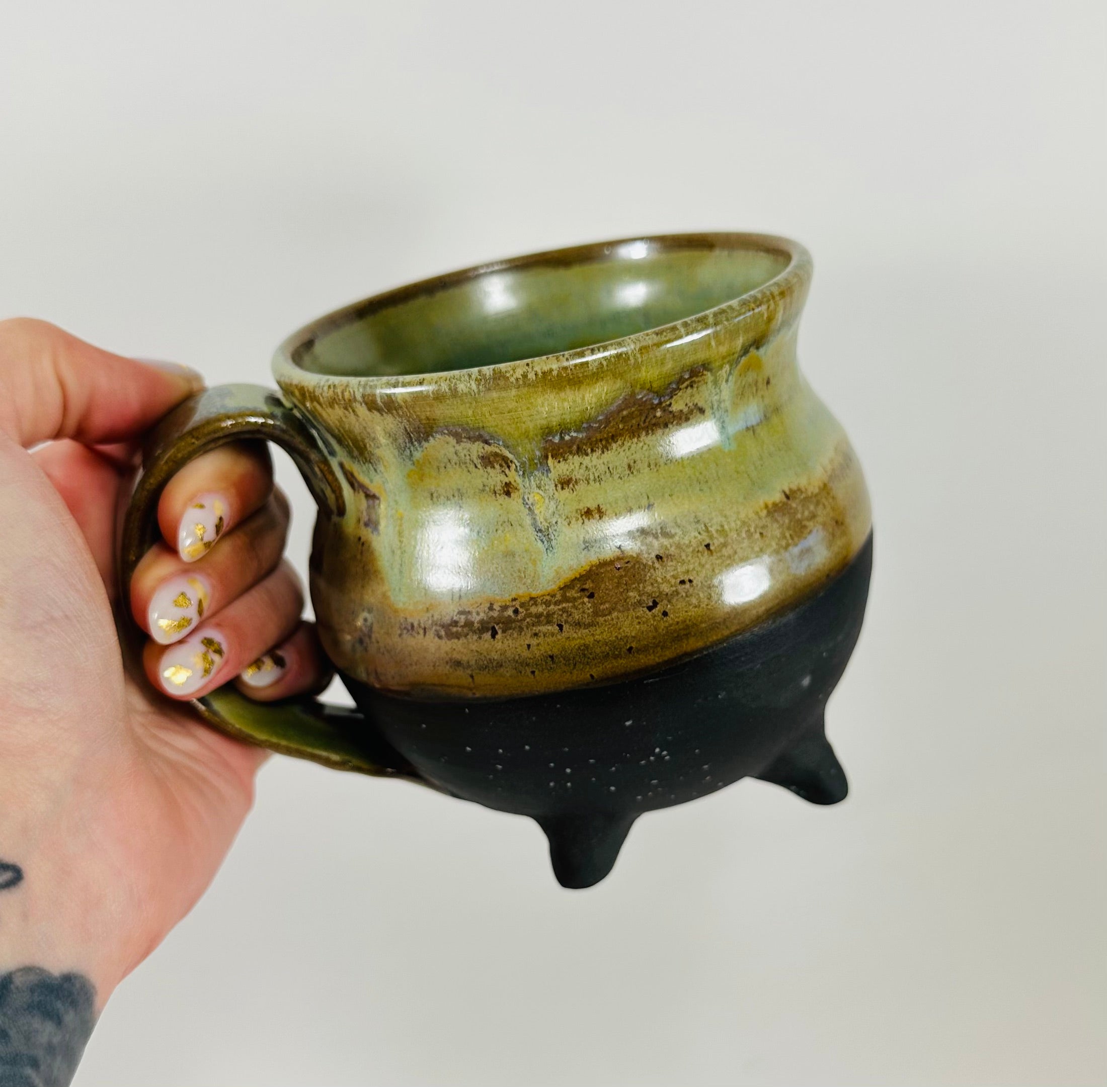 Handmade cauldron mug in a beautiful green and black glaze
