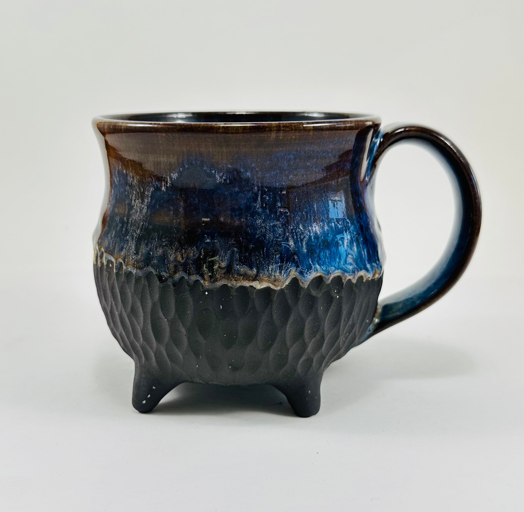 Handmade cauldron mug in a beautiful blue and black glaze