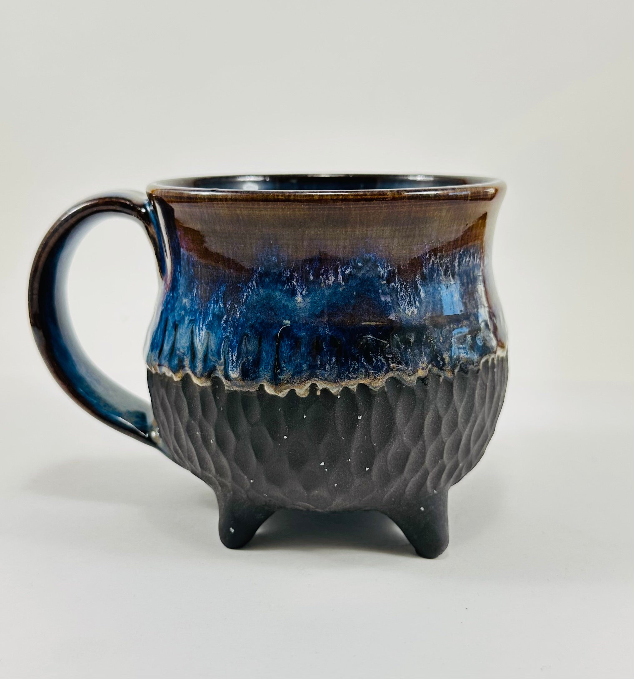 Handmade cauldron mug in a beautiful blue and black glaze