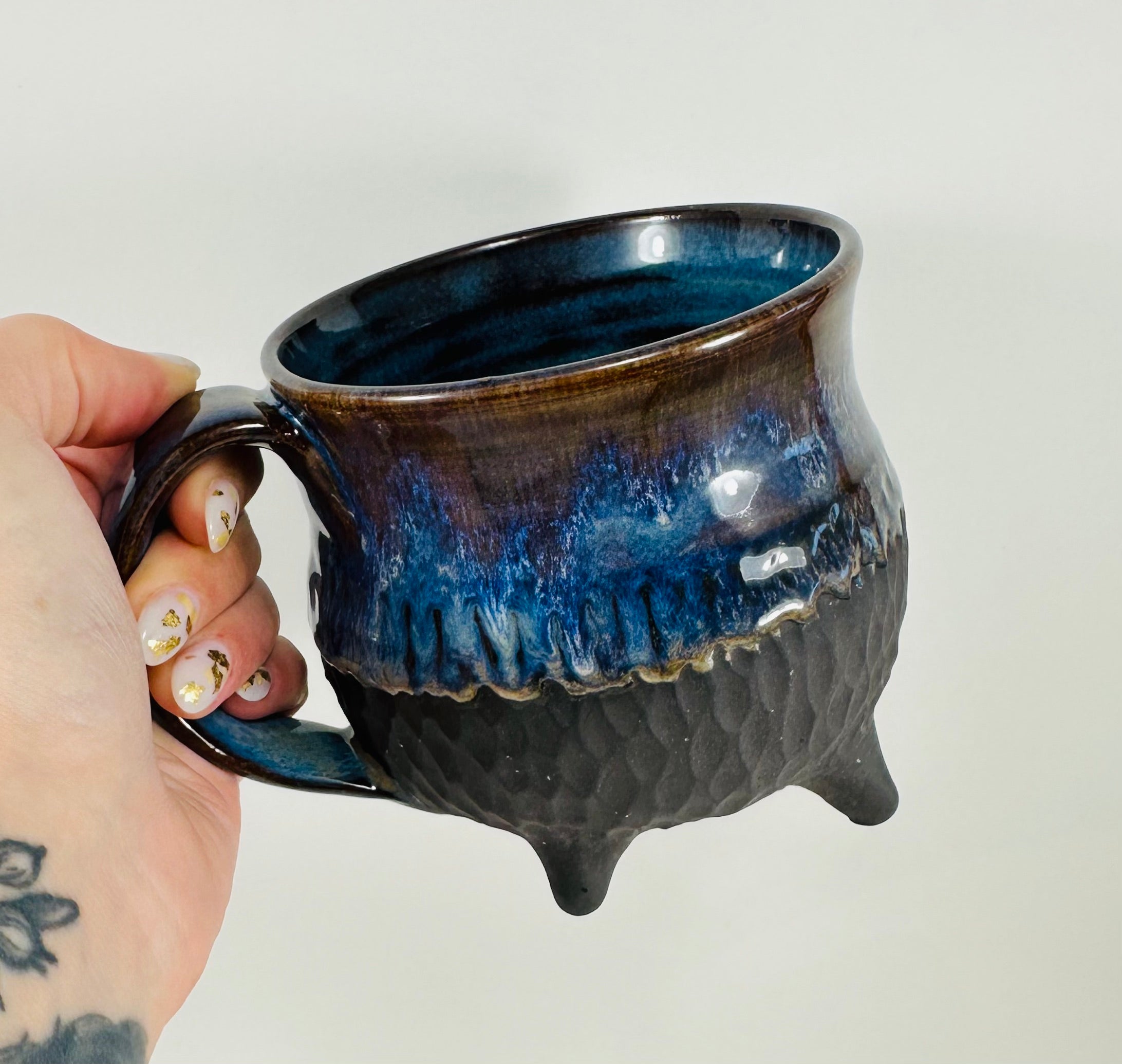 Handmade cauldron mug in a beautiful blue and black glaze