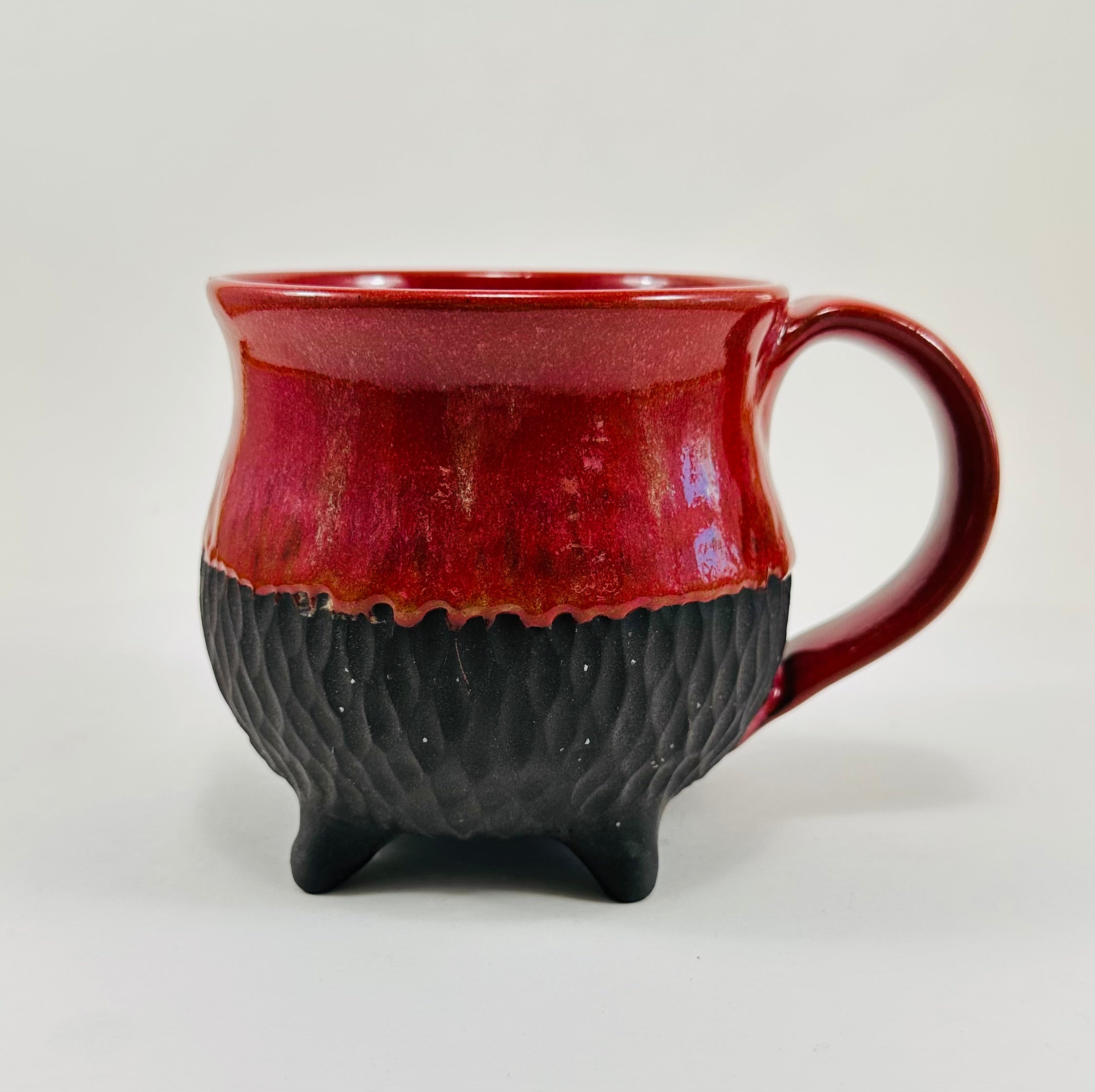 Handmade cauldron mug in a beautiful red and black glaze