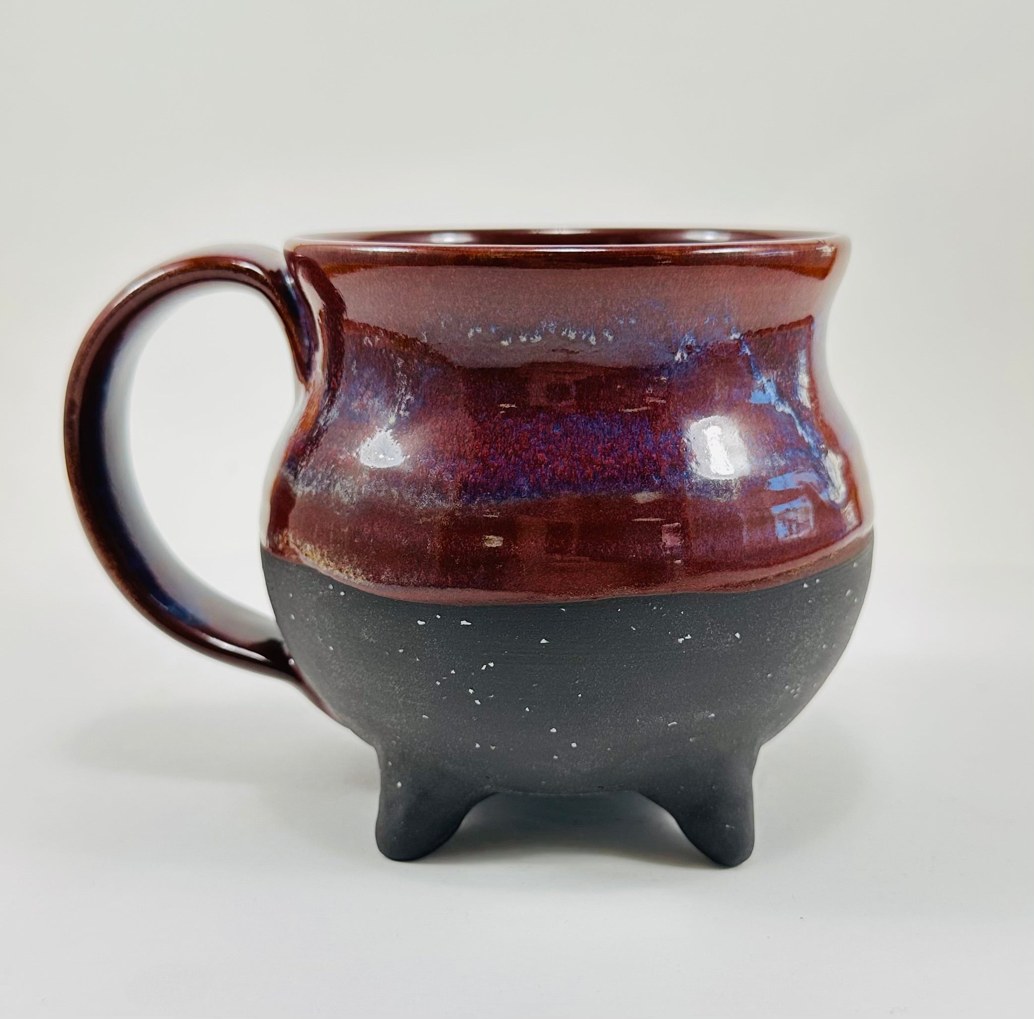 Handmade cauldron mug in a beautiful purple and black glaze