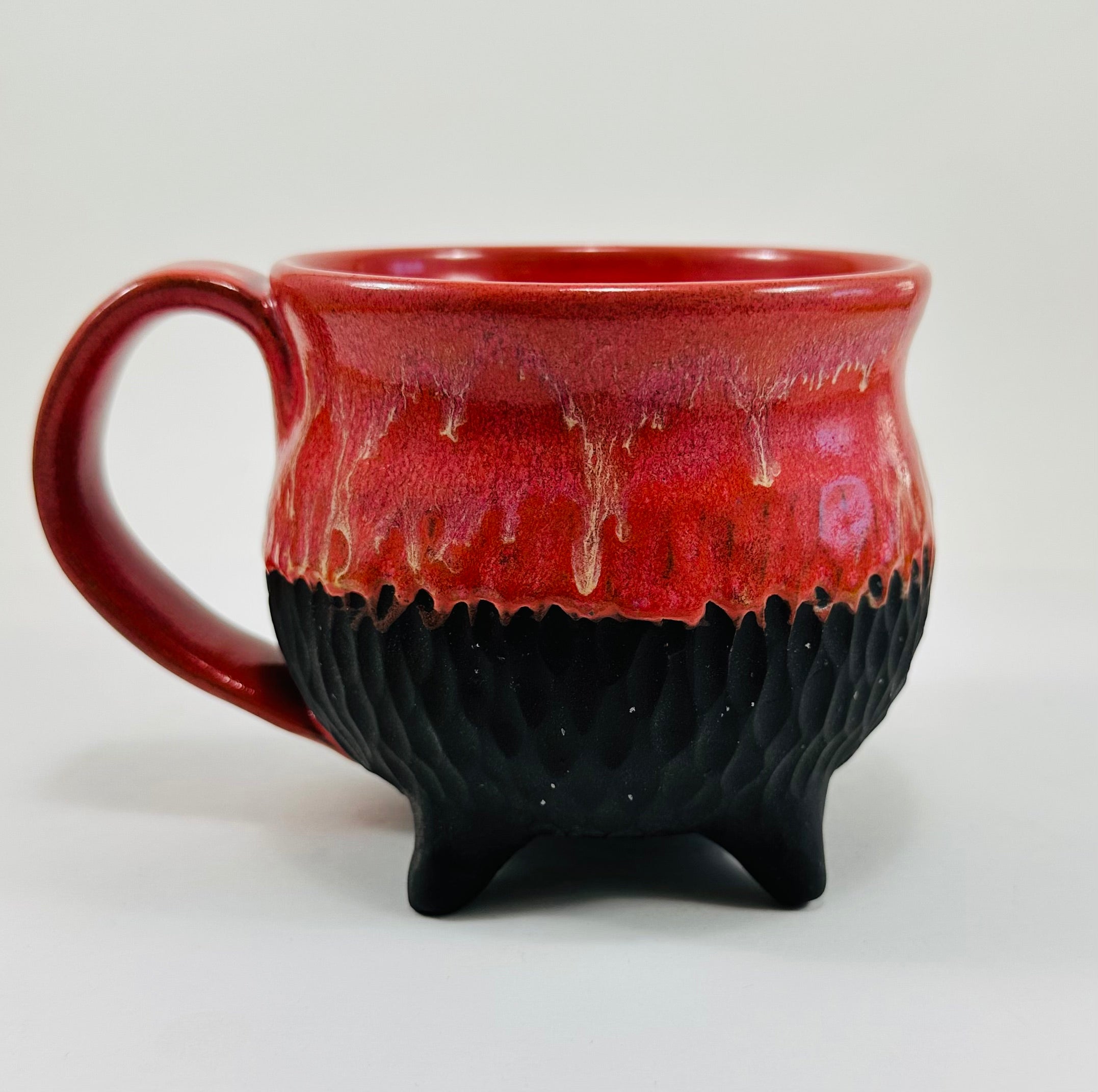 Handmade cauldron mug in a beautiful red and black glaze