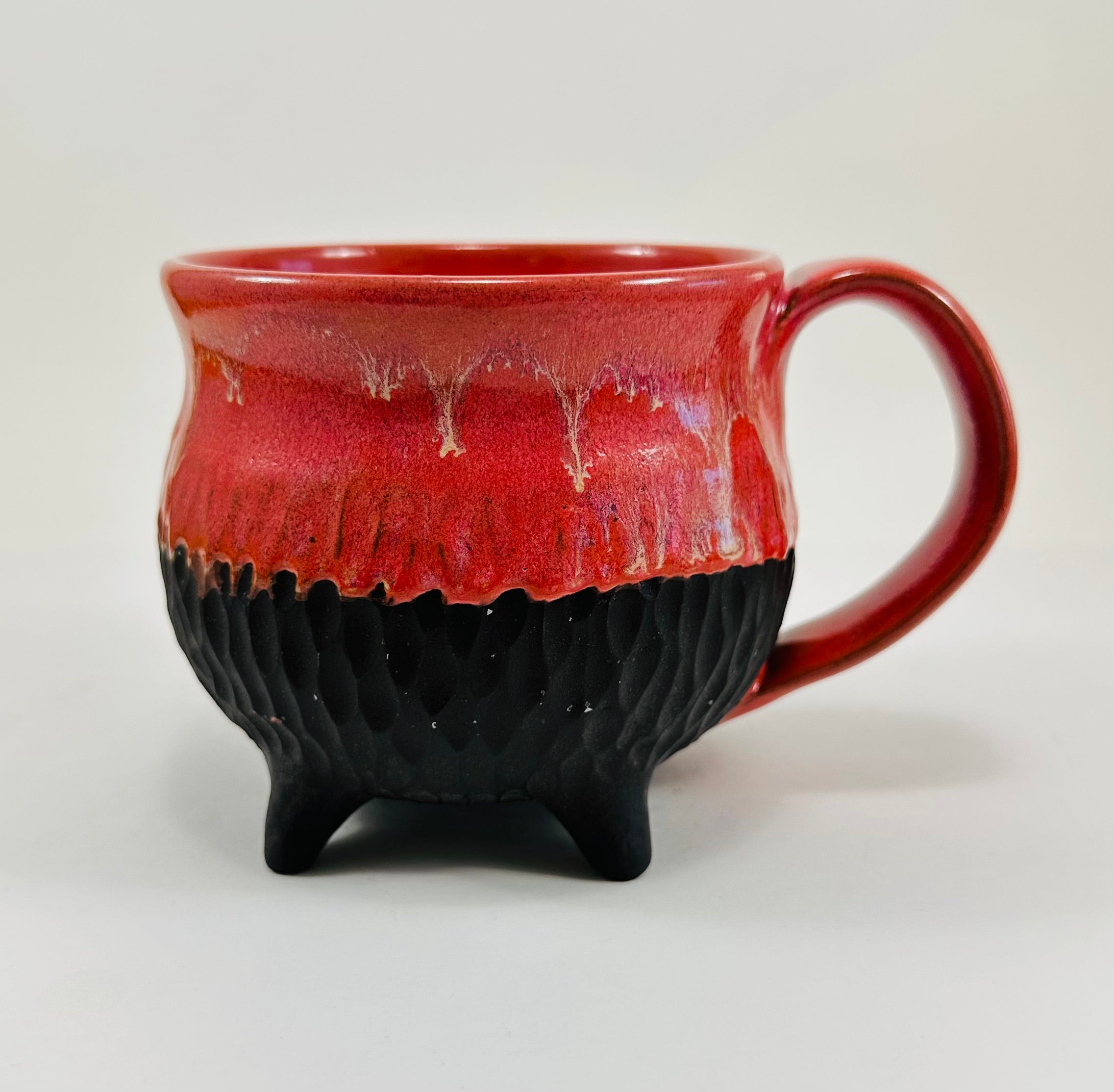 Handmade cauldron mug in a beautiful red and black glaze
