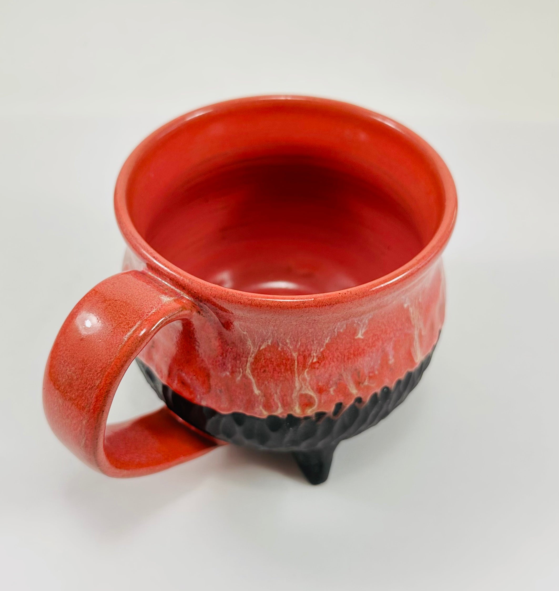 Handmade cauldron mug in a beautiful red and black glaze