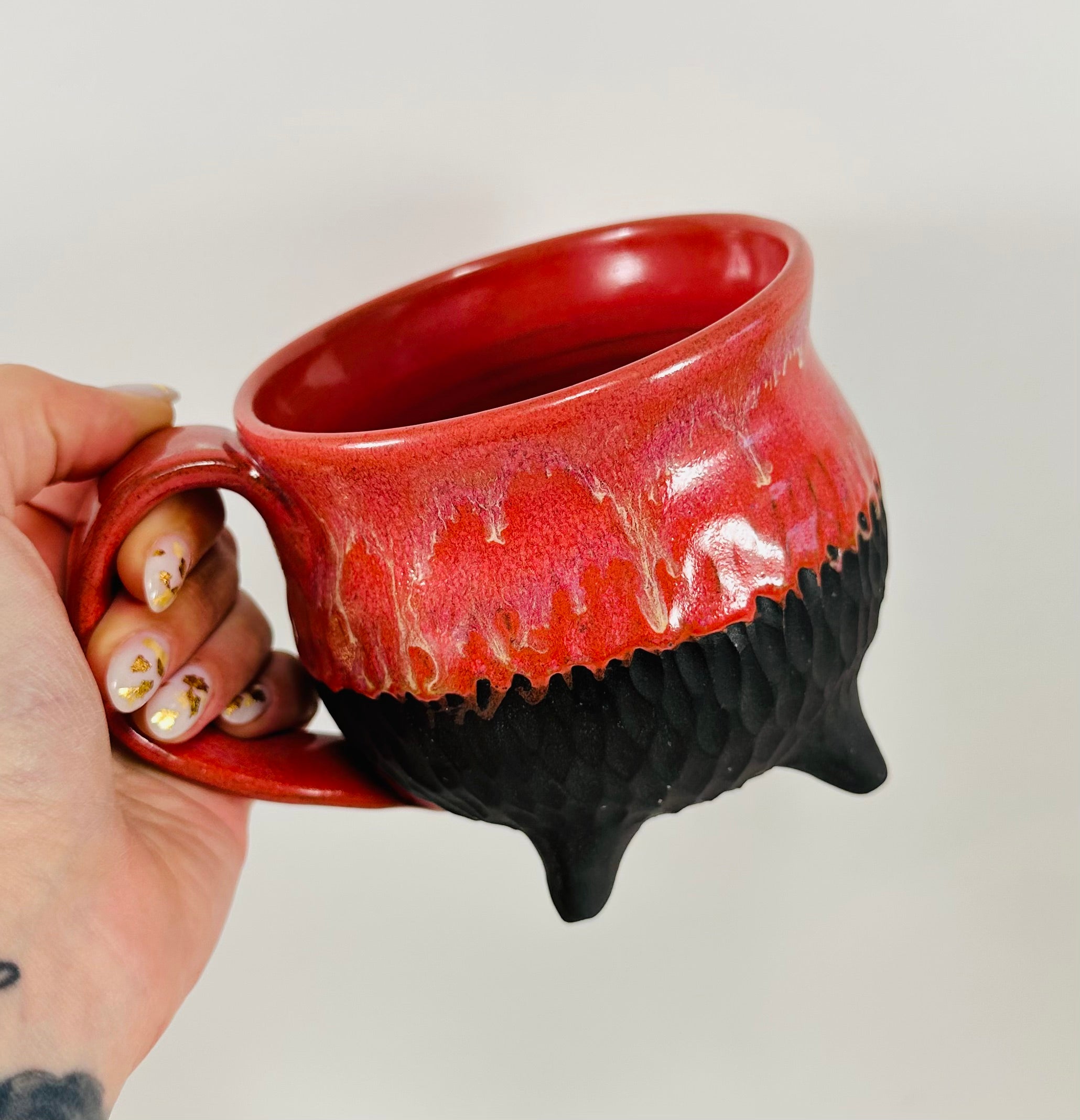 Handmade cauldron mug in a beautiful red and black glaze