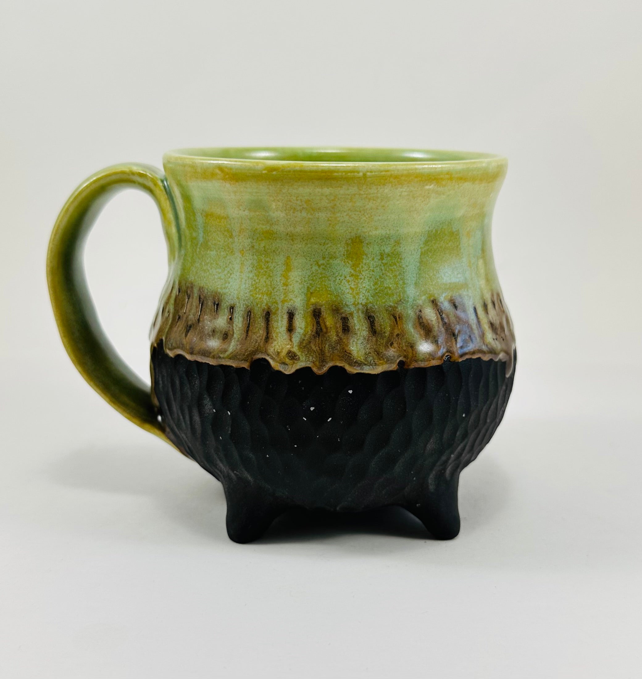 Handmade cauldron mug in a beautiful green and black glaze