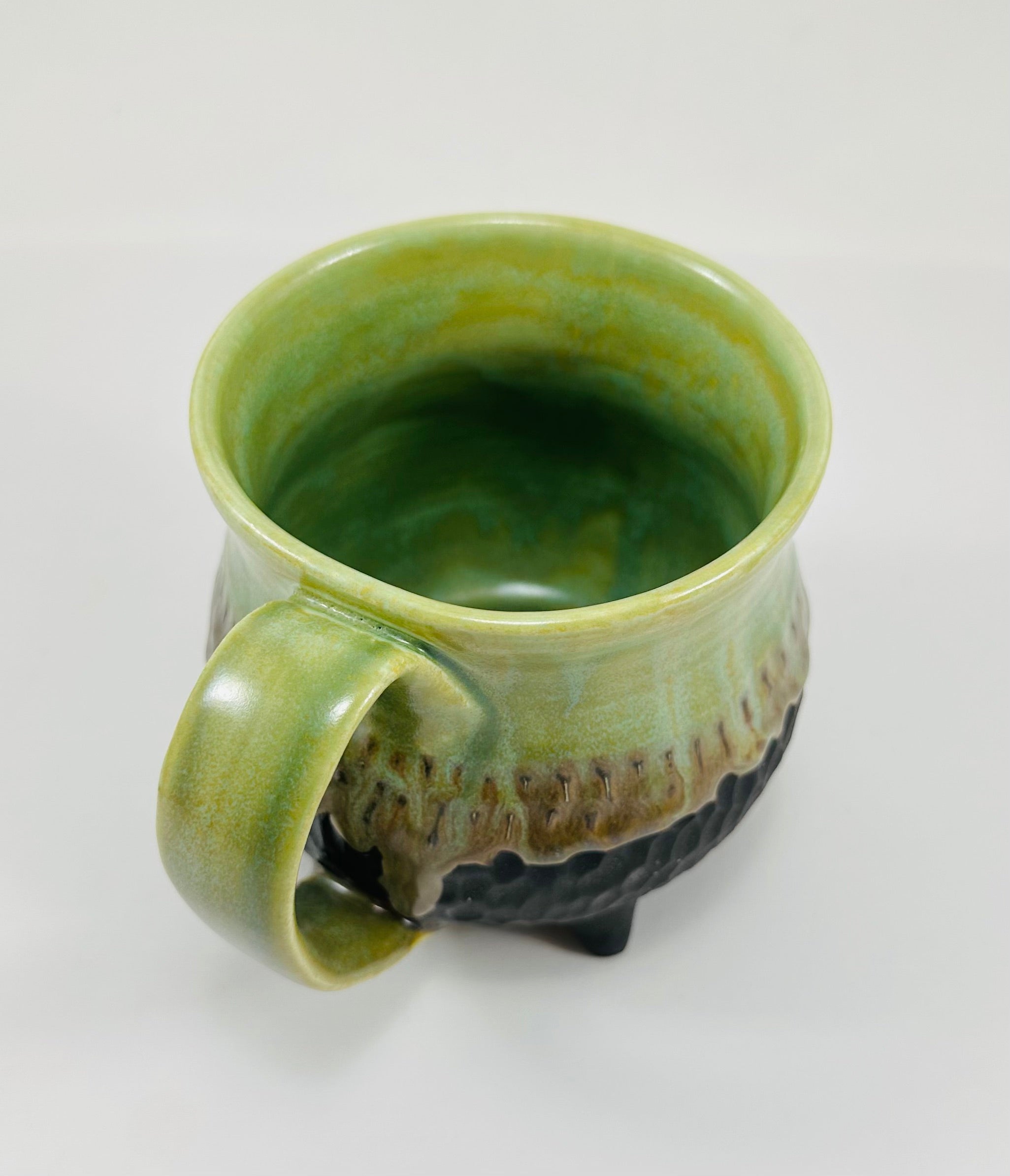 Handmade cauldron mug in a beautiful green and black glaze