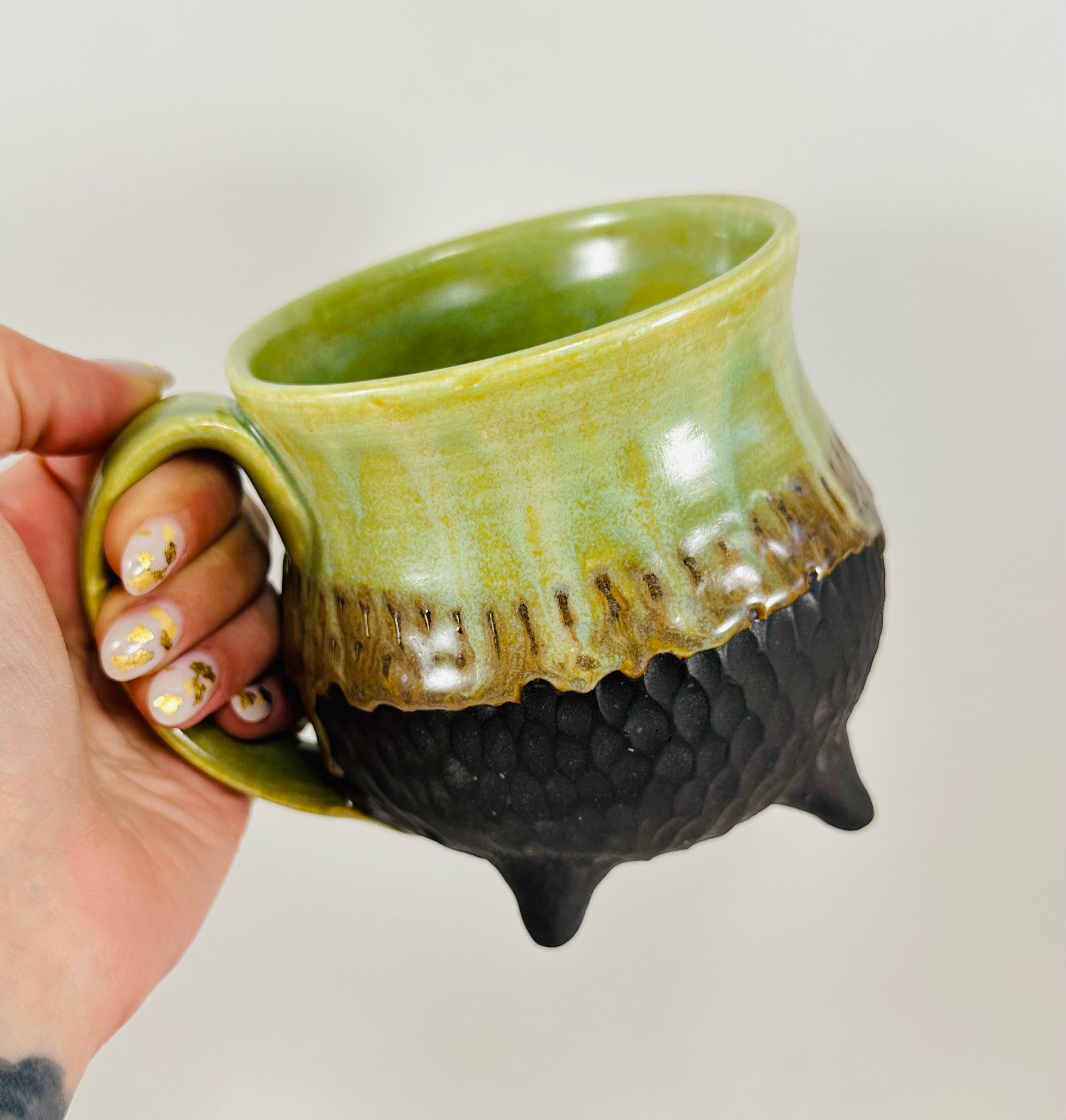Handmade cauldron mug in a beautiful green and black glaze