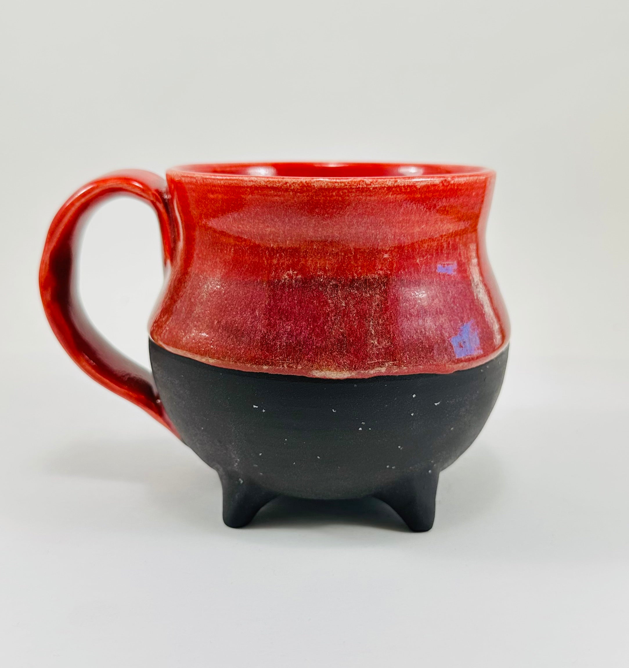 Handmade cauldron mug in a beautiful red and black glaze