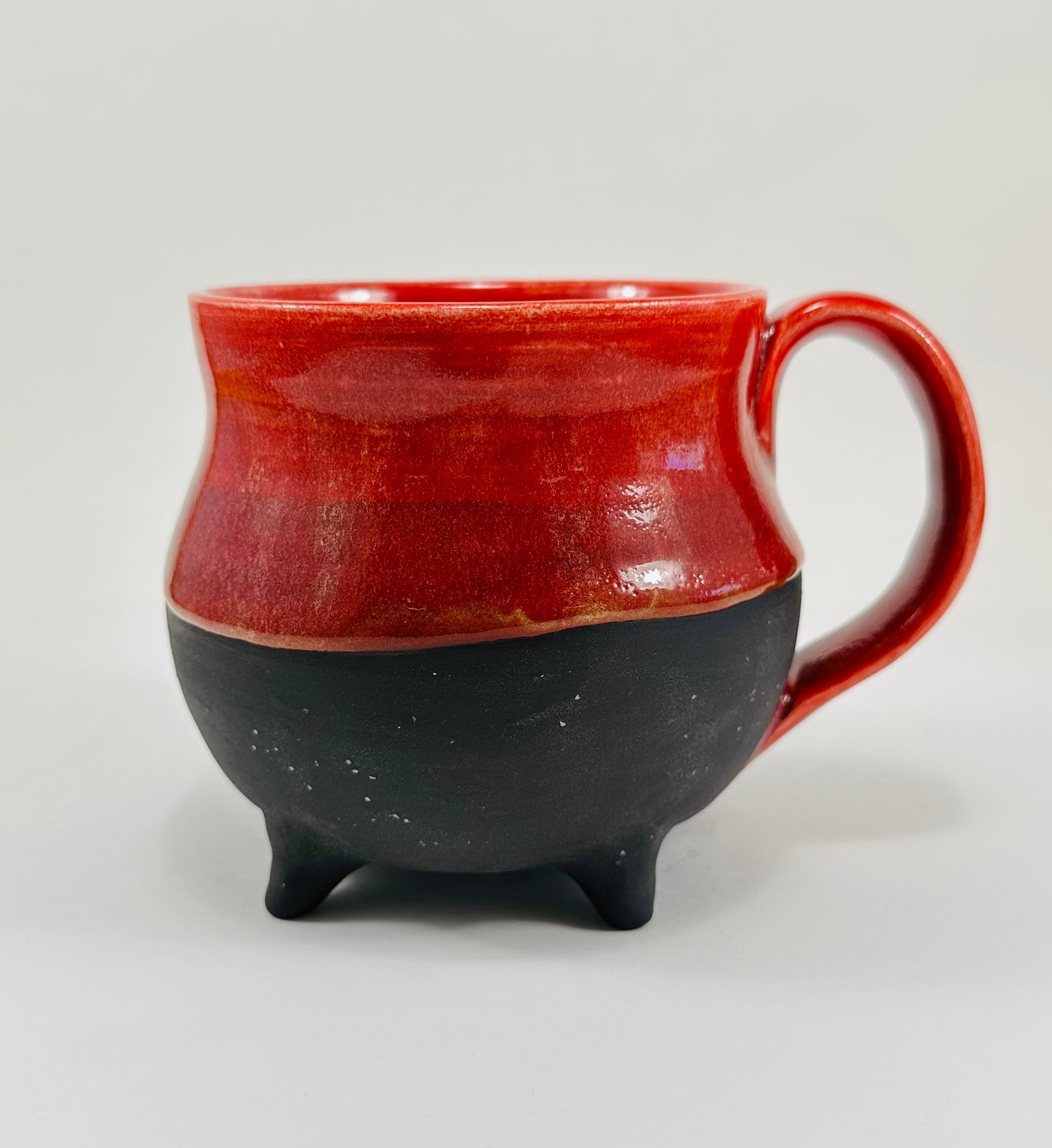 Handmade cauldron mug in a beautiful red and black glaze