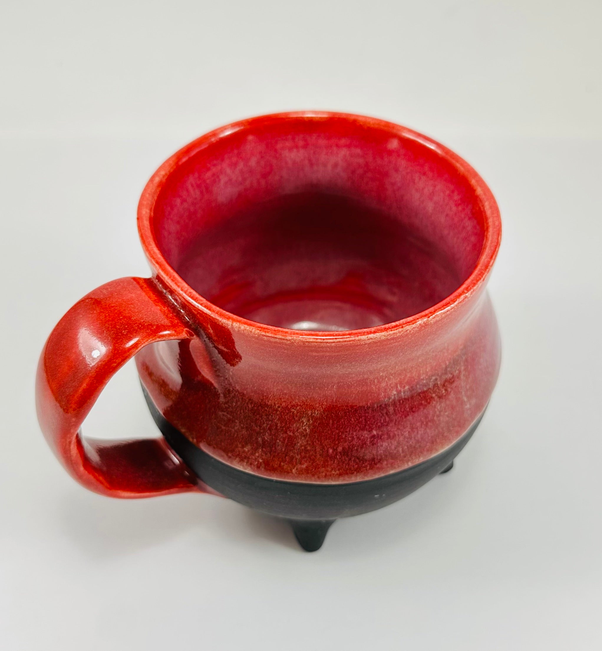 Handmade cauldron mug in a beautiful red and black glaze