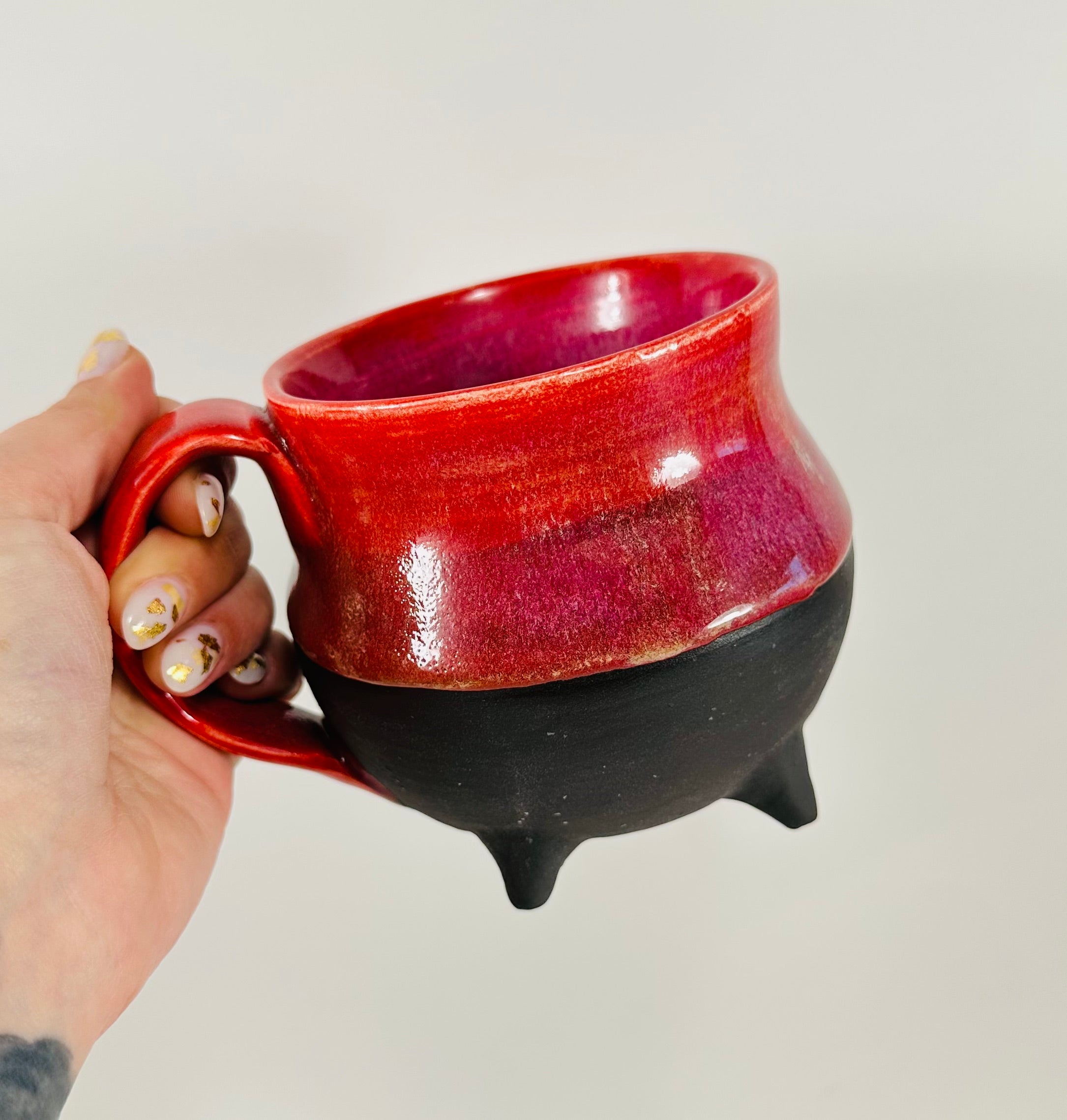 Handmade cauldron mug in a beautiful red and black glaze