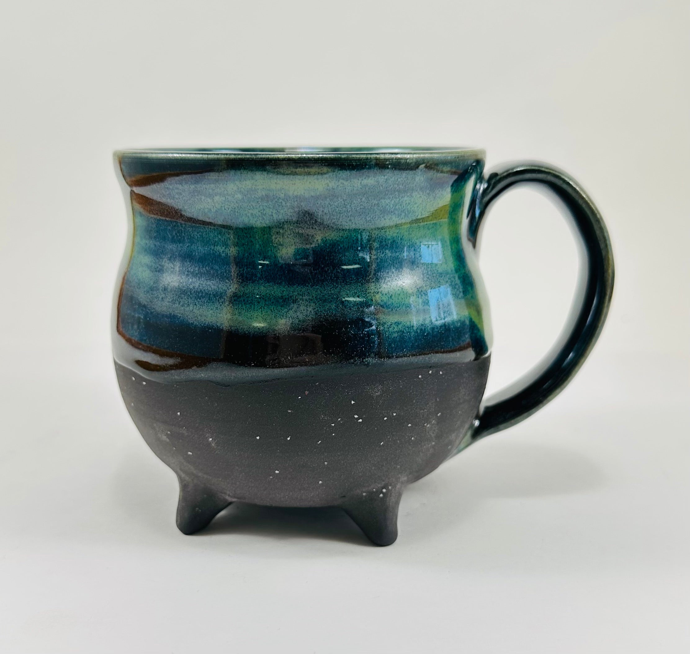 Handmade cauldron mug in a beautiful blue, green and black glaze