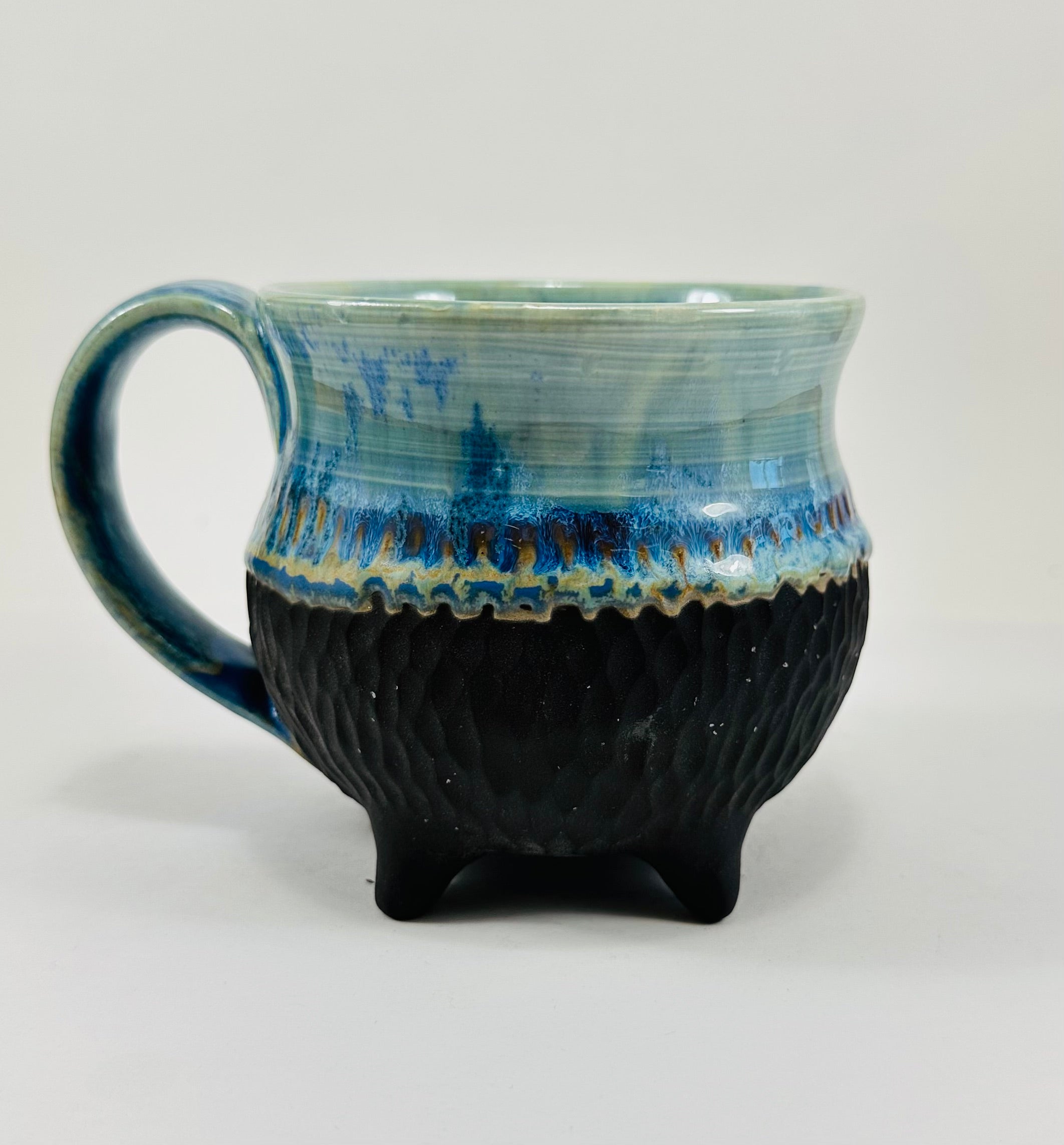Handmade cauldron mug in a beautiful blue and black glaze