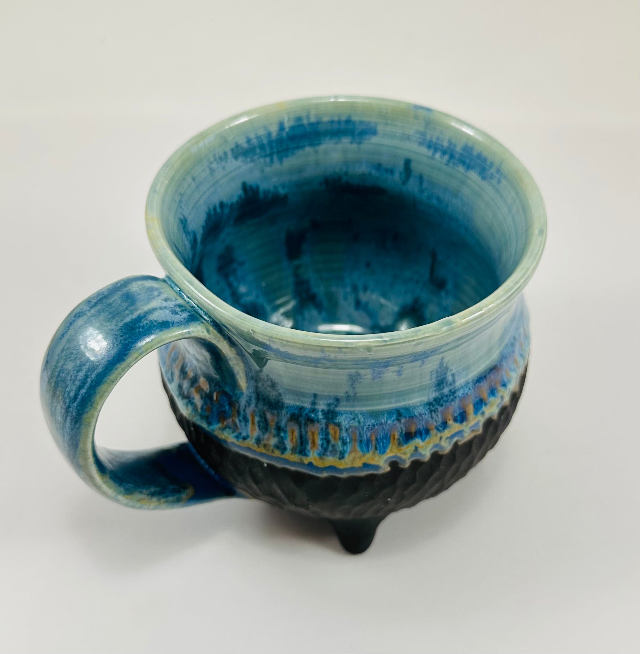 Handmade cauldron mug in a beautiful blue and black glaze