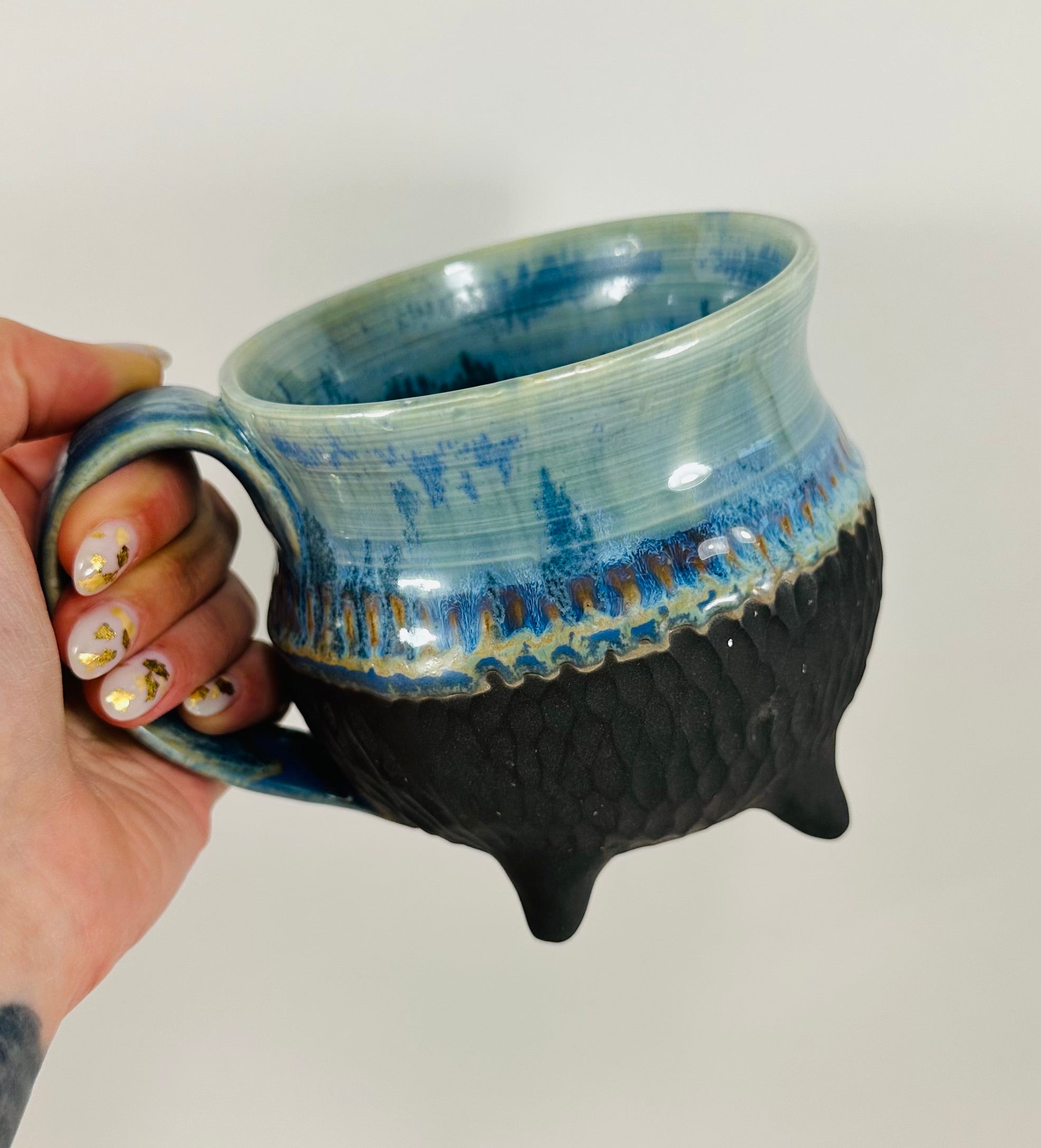 Handmade cauldron mug in a beautiful blue and black glaze