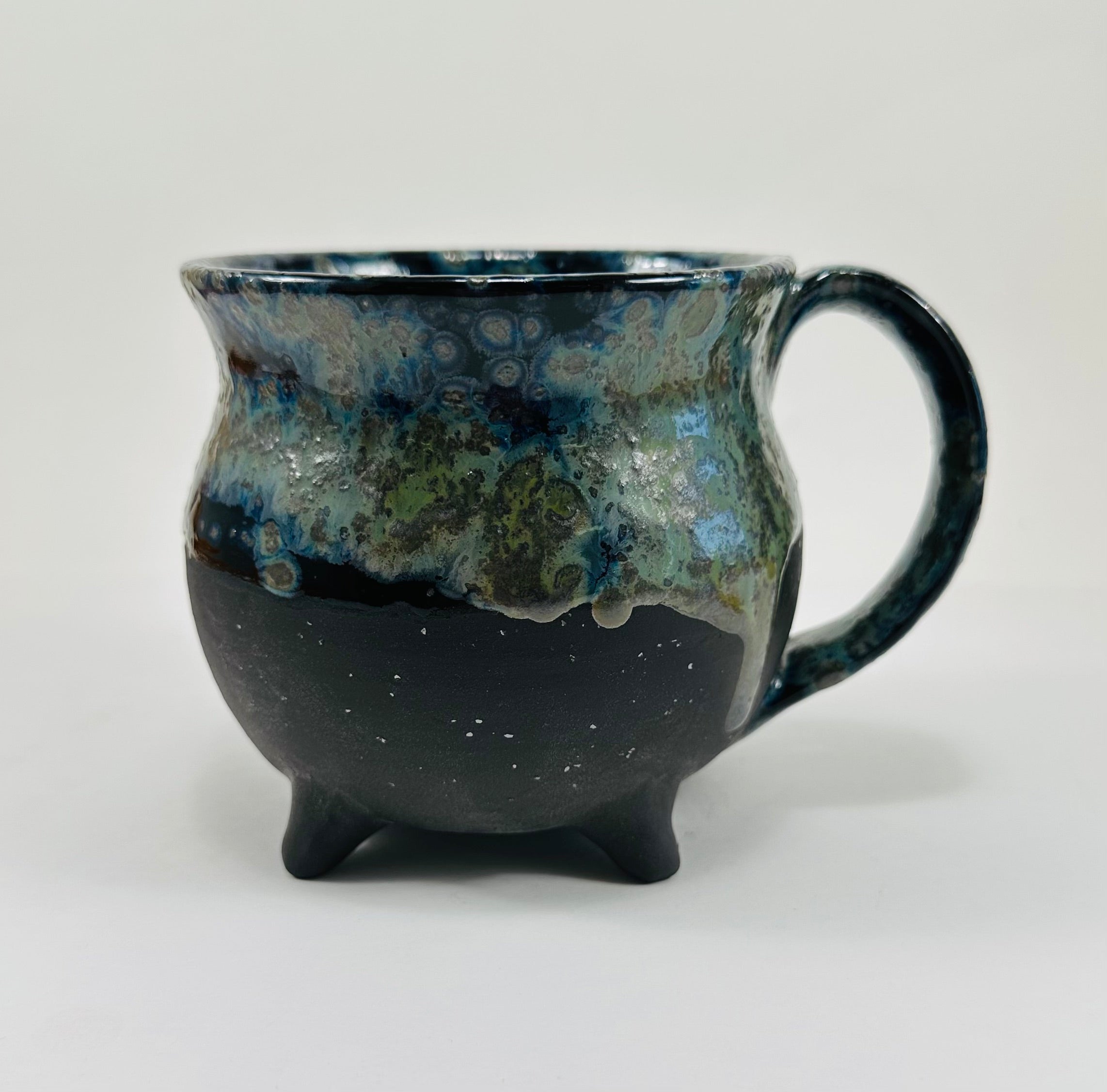 Handmade cauldron mug in a beautiful blue, green and black glaze