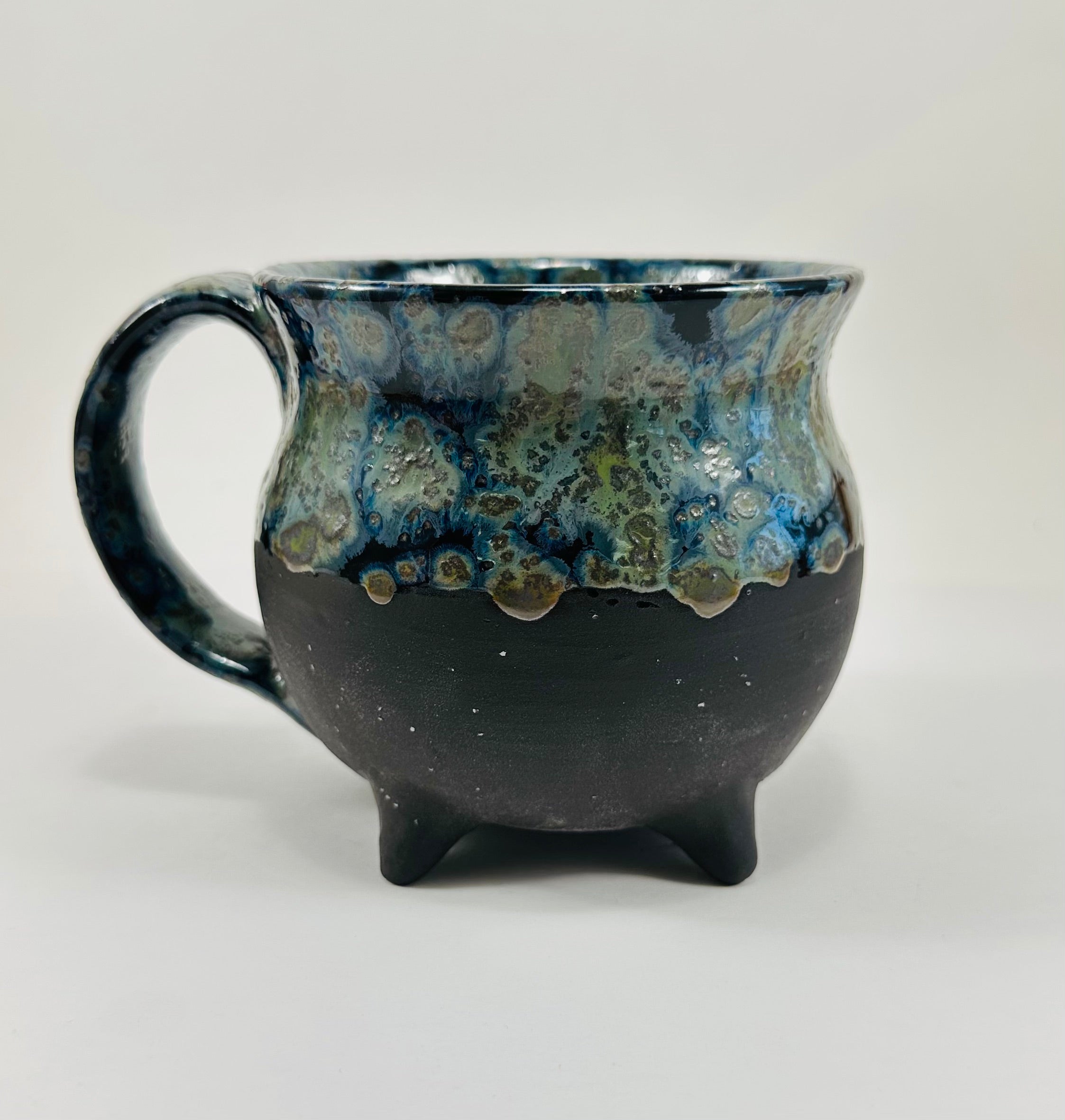 Handmade cauldron mug in a beautiful blue, green and black glaze