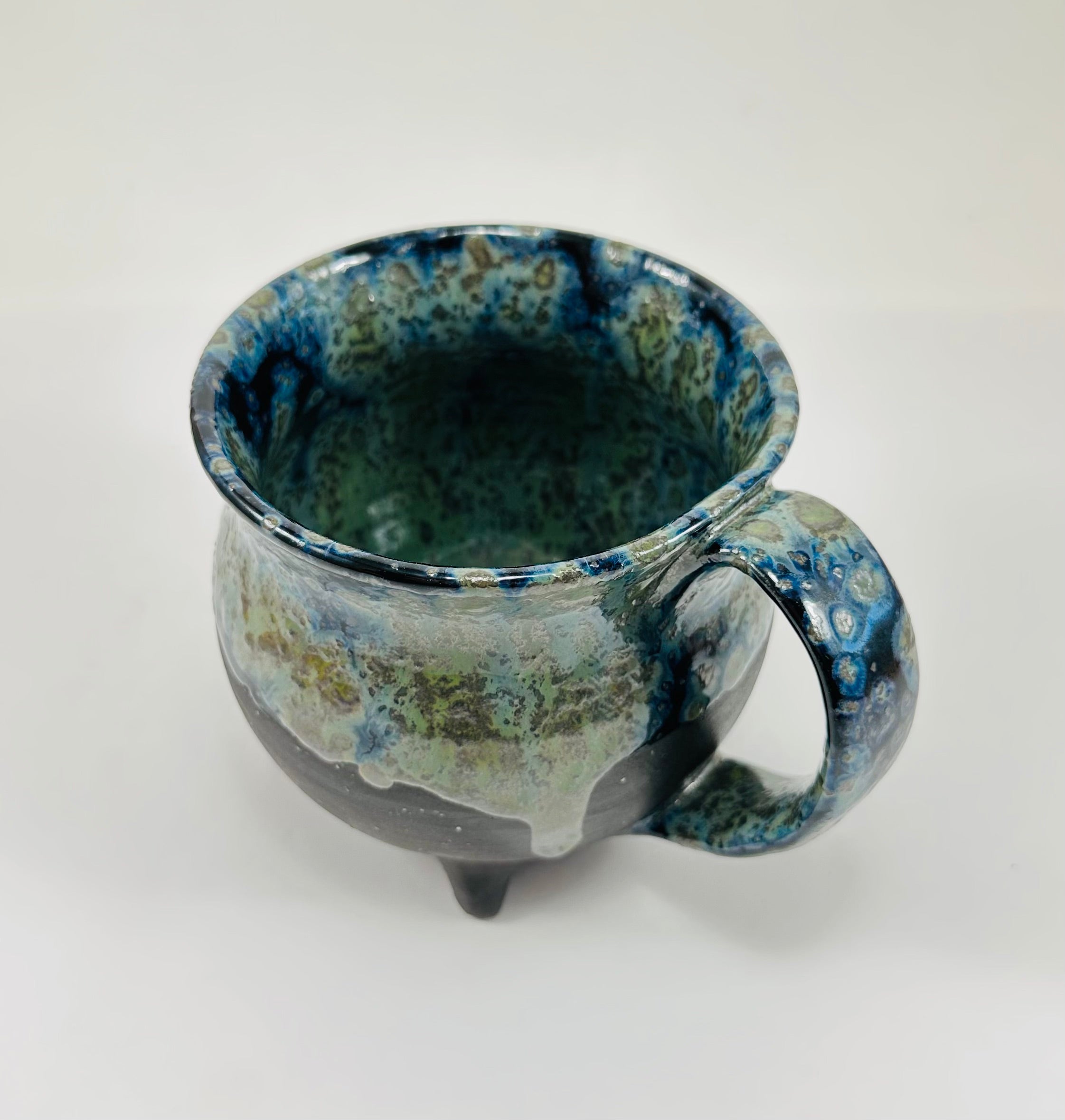 Handmade cauldron mug in a beautiful blue, green and black glaze